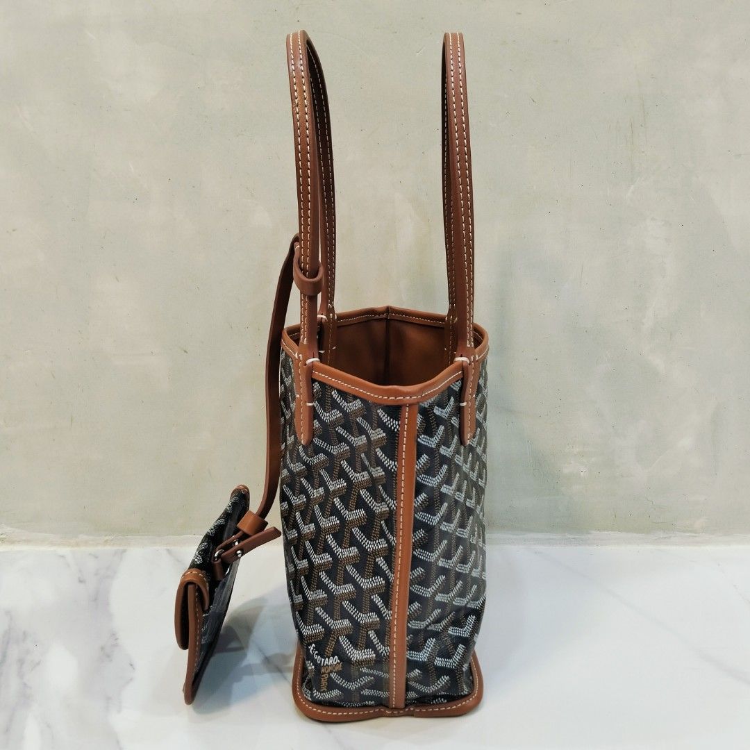 Goyard Mini Tote Bag with Pouch (Category: Luxury Bags & Wallets) located in Dagupan City. Submitted by youngthrift_ (Listing ID 1417847329, Image 3). Description: Goyard mini tote bag with matching pouch. Features the signature Goyardine pattern in black and brown. The bag has brown leather trim and handles with white stitching. The pouch has a snap closure and is stamped with "Goyard Paris Made in France". The interior of the bag is brown leath
