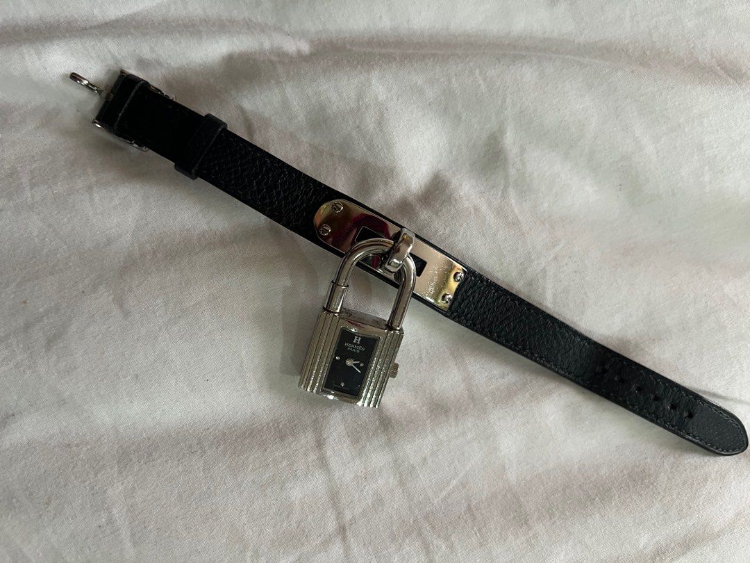 Hermes Kelly Watch (Category: Luxury Watches) located in Taguig. Submitted by timeandplace (Listing ID 1417861302, Image 2). Description: - Hermes Kelly watch - Dark blue leather strap - Silver-tone padlock-shaped watch face - Black dial with silver-tone hands and markers - Buckle closure - Stylish accessory, iconic.