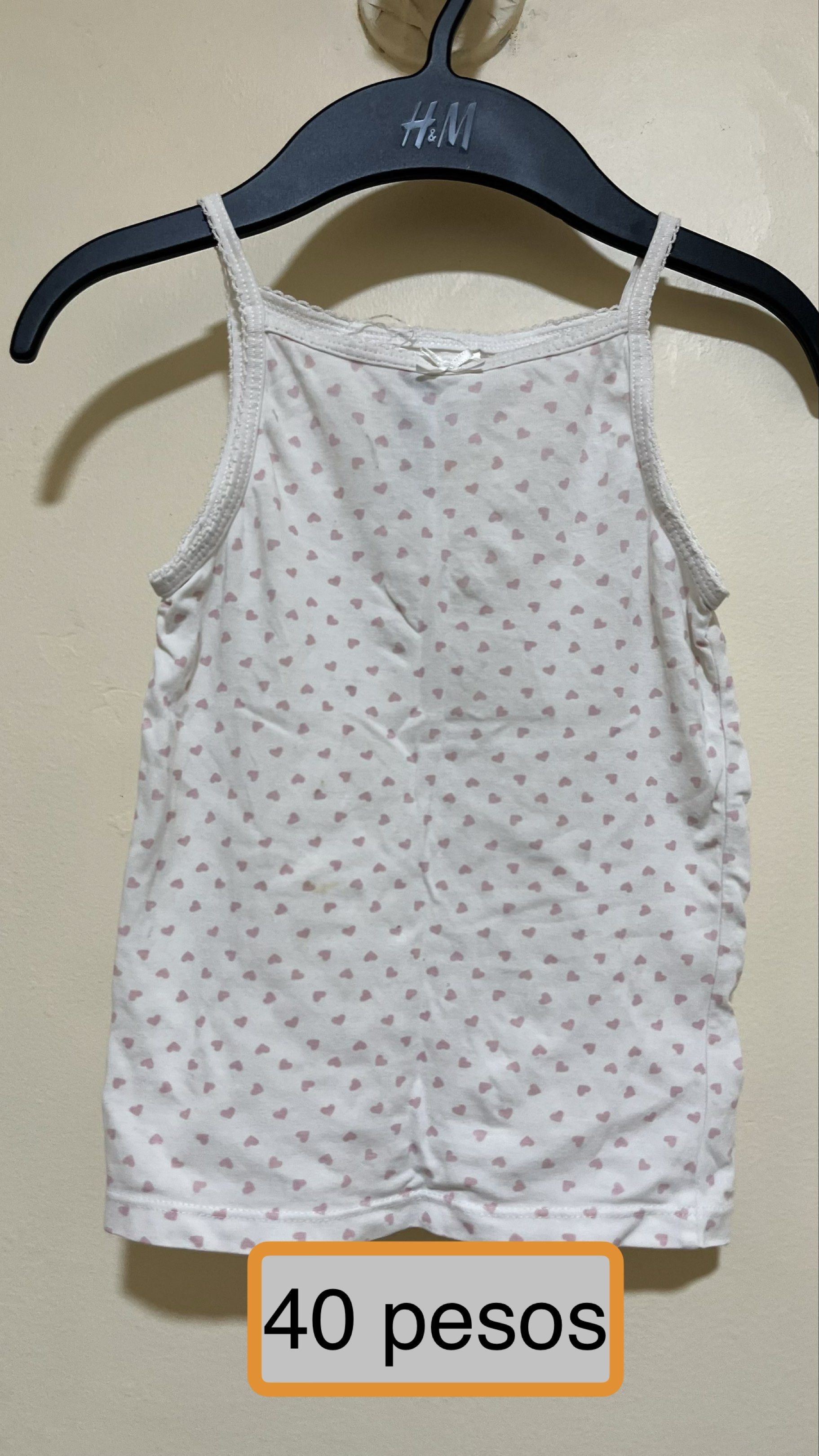H&M Heart Print Tank Top (Category: Babies & Kids Fashion) located in Paranaque City. Submitted by aeyprel (Listing ID 1417813449, Image 1). Description: - H&M tank top - Sweet heart print - Delicate spaghetti straps - Cute bow detail - White with pink hearts - Perfect for everyday wear - Price: 40 pesos.