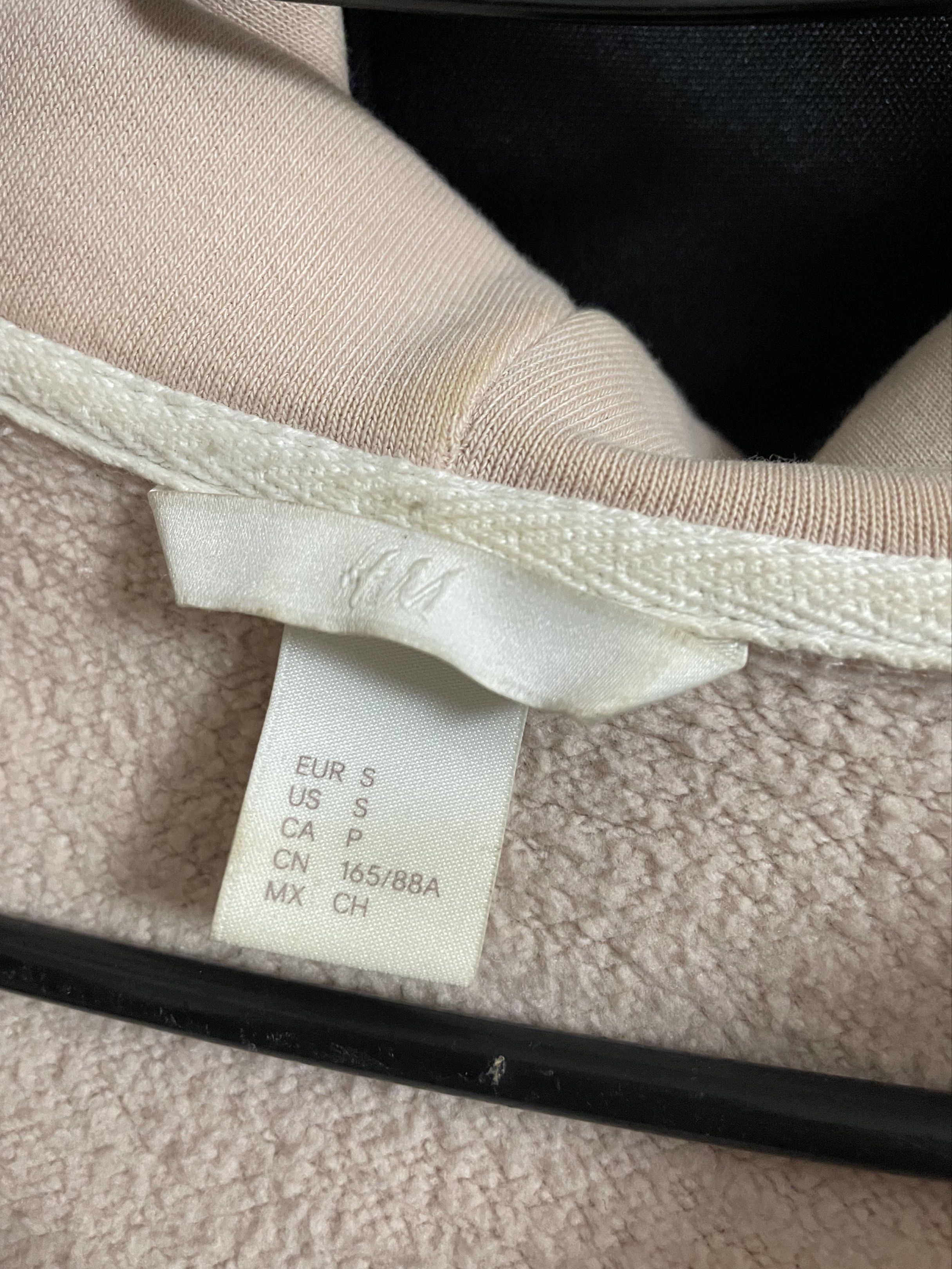 H&M Zip-Up Hoodie - Size S (Category: Hoodies) located in Manila. Submitted by kyletrvs (Listing ID 1417888279, Image 3). Description: H&M Jacket zip-up hoodie is a size S. It features a full zip closure, a hood, and long sleeves. The hoodie has a light beige color. There are some visible stains on the front. In need for wash.