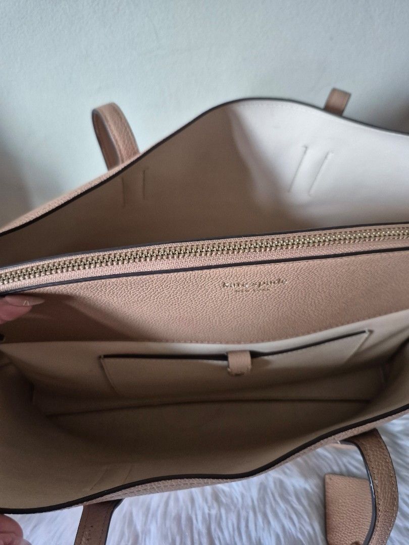 Kate Spade Margaux Large Tote Bag (Category: Tote Bags) located in Mandaluyong City. Submitted by mandybsa (Listing ID 1417825584, Image 3). Description: - Kate Spade tote bag - Neutral color - Top handles - Spacious interior with multiple compartments including cushioned zipped pocket for laptop and small interior pocket for cards - Textured leather - Interior lining in a lighter shade - Small tag detail - Price negotiable - Condition: Interior 