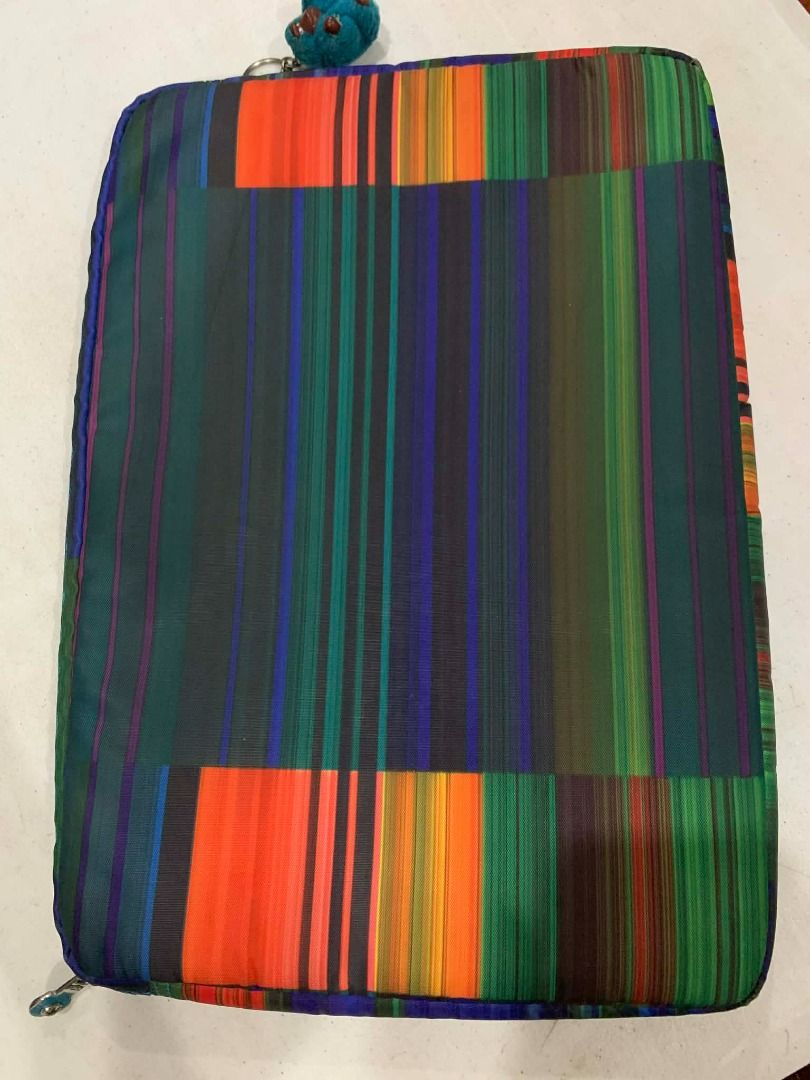 Kipling Laptop Sleeve (Category: Laptop Bags & Sleeves) located in Bacolod City. Submitted by kyaramatcha (Listing ID 1417958140, Image 3). Description: - Stylish Kipling laptop sleeve - Vibrant, colorful striped pattern - Working zipper - Soft interior lining - Includes Kipling monkey keychain - with Kipling logo - Protects your laptop.