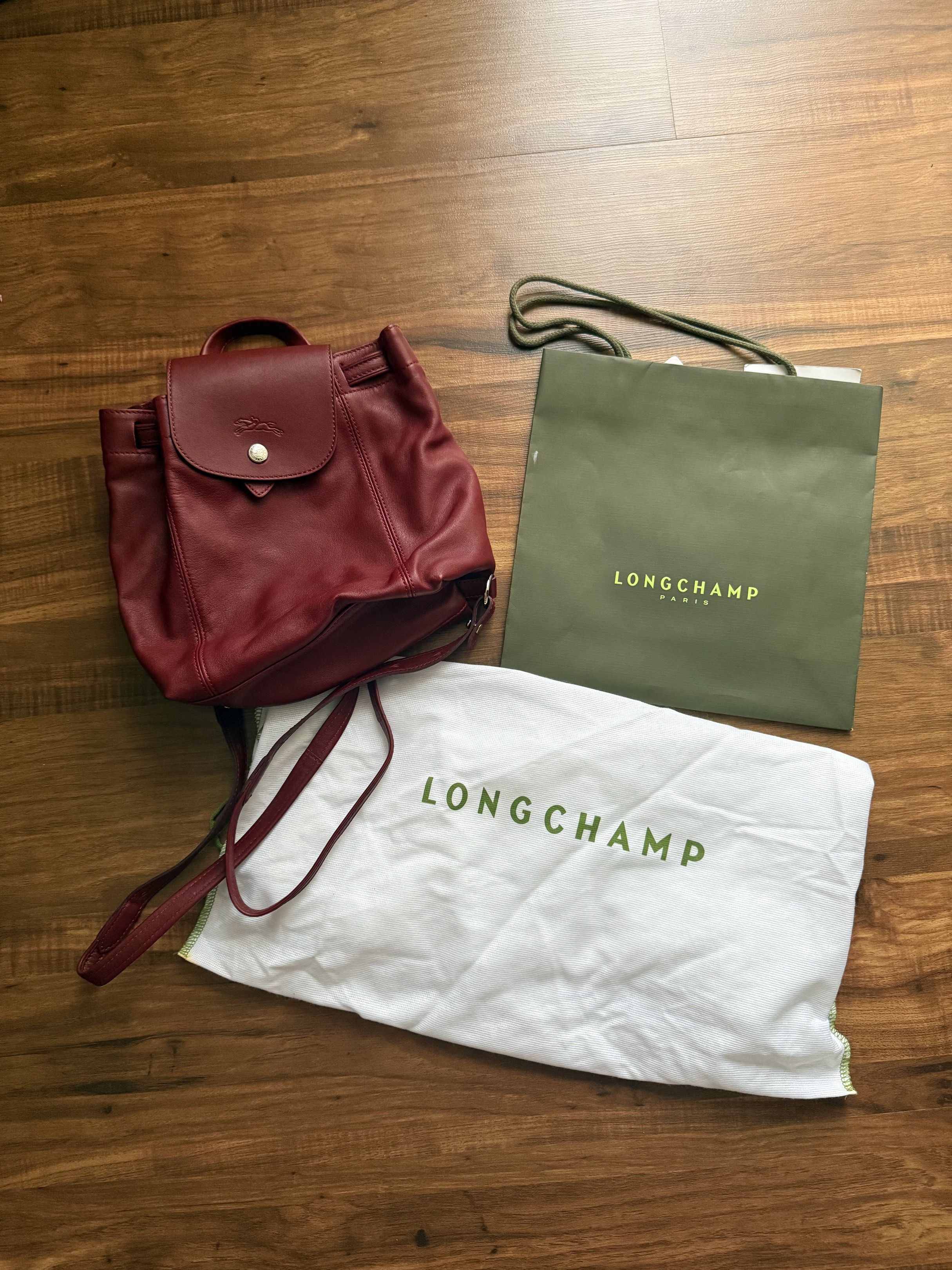 Longchamp Le Pliage leather backpack (Category: Luxury Bags & Wallets) located in Mandaluyong City. Submitted by triciaaaas (Listing ID 1417831444, Image 1). Description: Model / Style: Le Pliage Leather Backpack Color: Burgundy Material: Premium soft leather with durable nylon accents (signature Longchamp quality) Features: • Elegant & timeless design — classic Longchamp look • High-quality leather construction — soft yet durable • Spacious inte