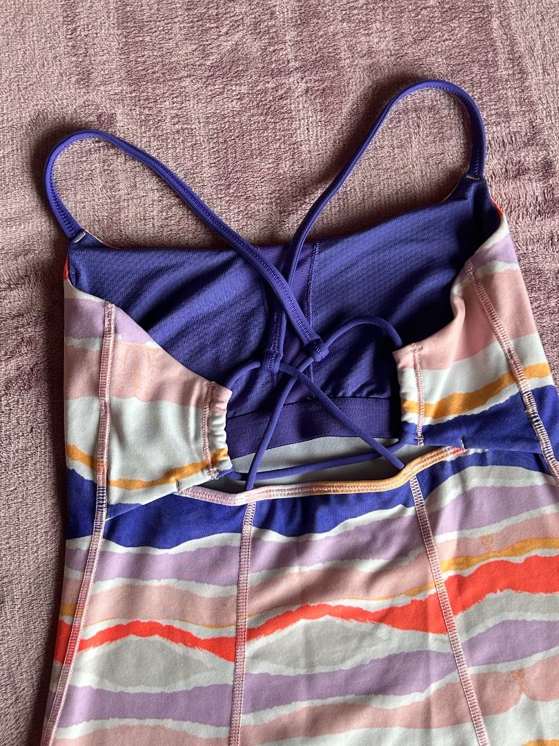 Lululemon Dancing Warrior Tank (Category: Activewear) located in Quezon City. Submitted by martits (Listing ID 1417935228, Image 3). Description: Authentic Lululemon · Dot size: 4 Colorful striped pattern - Color palette: Purple, orange, pink, and white - Built-in bra with unique criss-cross back straps (no pads) - Scoop neck - Fitted silhouette - Made from lightweight athletic material - Compressive and slimming! - Can be worn as tankini top.