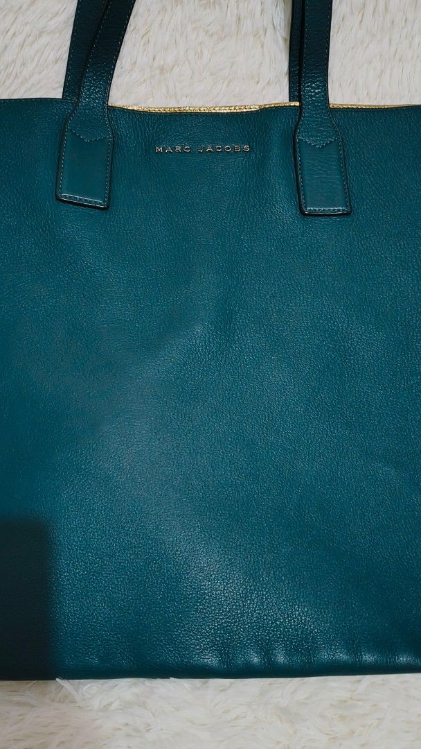 Marc Jacobs Teal Tote Bag (Category: Luxury Bags & Wallets) located in Pasig City. Submitted by lfboutique (Listing ID 1417859417, Image 3). Description: - original almost new Marc Jacobs tote bag - Beautiful teal color - Spacious interior with gold lining - Includes matching pouch - Sturdy handles - Detachable strap - Marc Jacobs logo visible - Perfect for any occasion pasig loc no cod lalamove or j&t.
