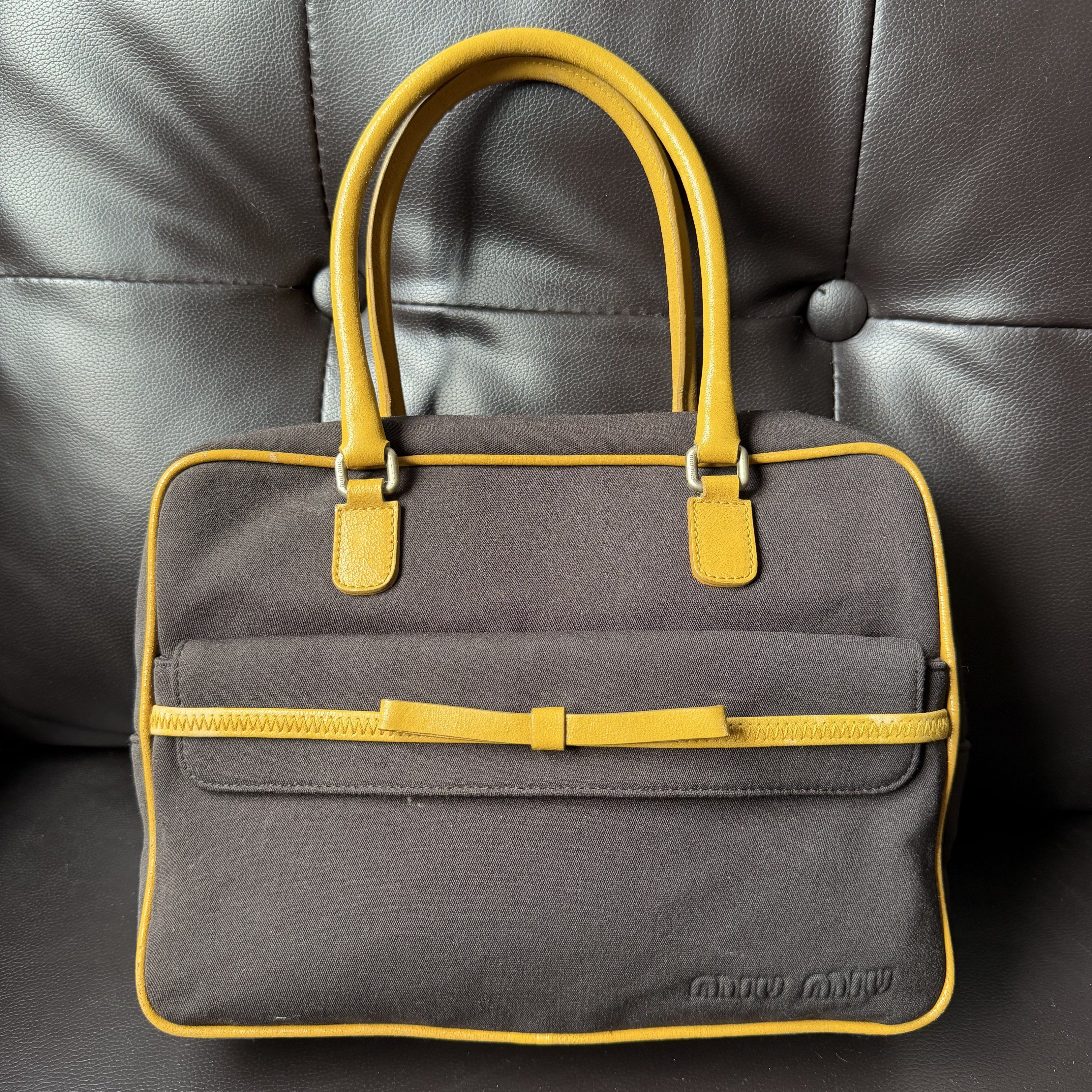 Miu Miu - 2000’s Bow Tie Hand Bag (Category: Luxury Bags & Wallets) located in Cavite. Submitted by 4118.ph (Listing ID 1417897389, Image 1). Description: 9/10 condition Bag itself no other inclusions Minor cracks on all leather part which is normal on vintage bag Also check the last photo for the other flaw.