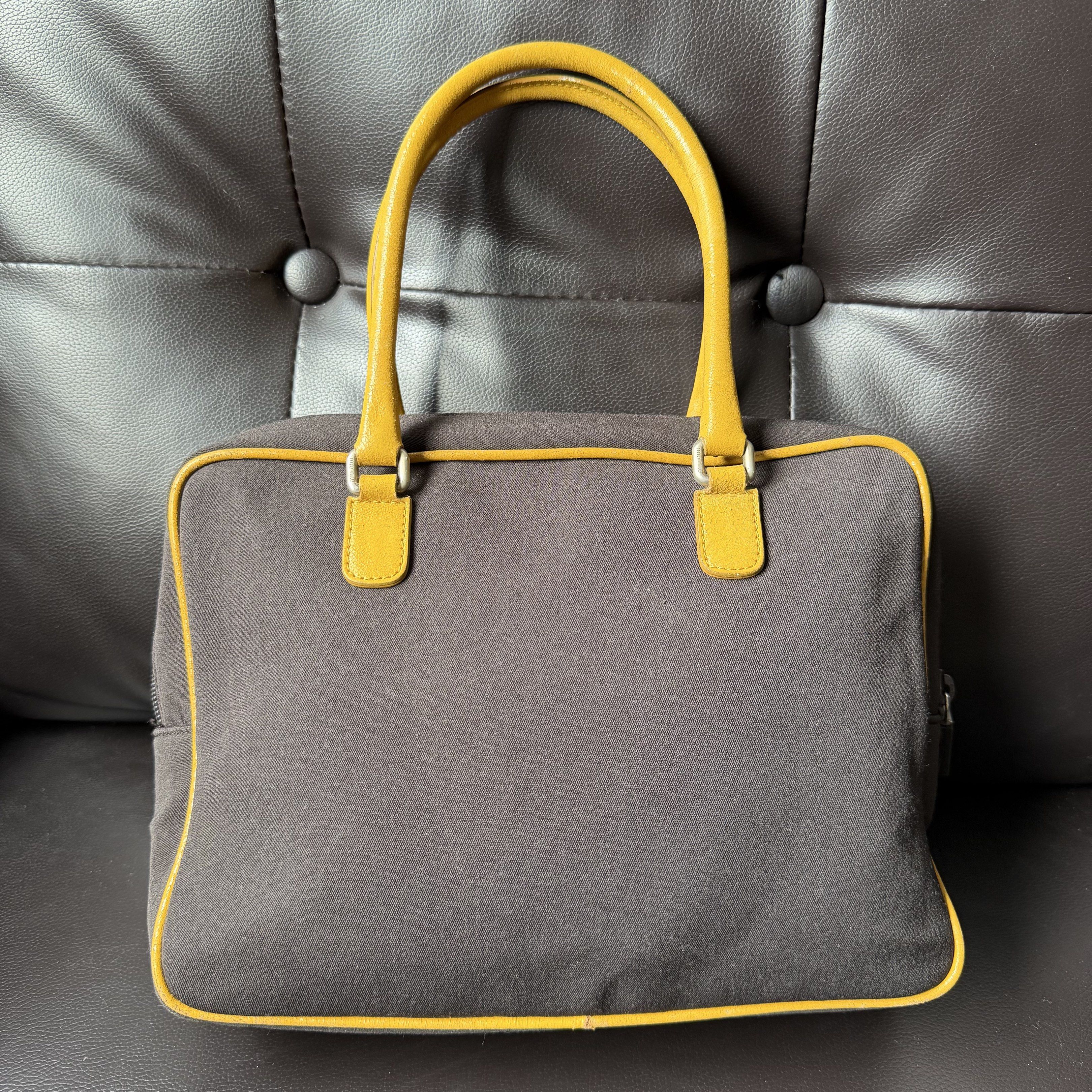 Miu Miu - 2000’s Bow Tie Hand Bag (Category: Luxury Bags & Wallets) located in Cavite. Submitted by 4118.ph (Listing ID 1417897389, Image 2). Description: 9/10 condition Bag itself no other inclusions Minor cracks on all leather part which is normal on vintage bag Also check the last photo for the other flaw.