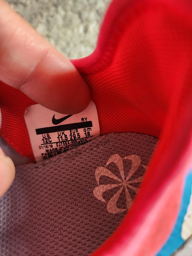 Nike Free Run Shoes - Size 12C (Category: Babies & Kids Fashion) located in Pasig City. Submitted by closetspaced (Listing ID 1417839687, Image 2). Description: - Nike Free Run shoes - Color: Red and Grey - Size: 12C - Easy wear with hook-and-loop strap - Breathable mesh design - Blue accent detail - Nike logo visible.