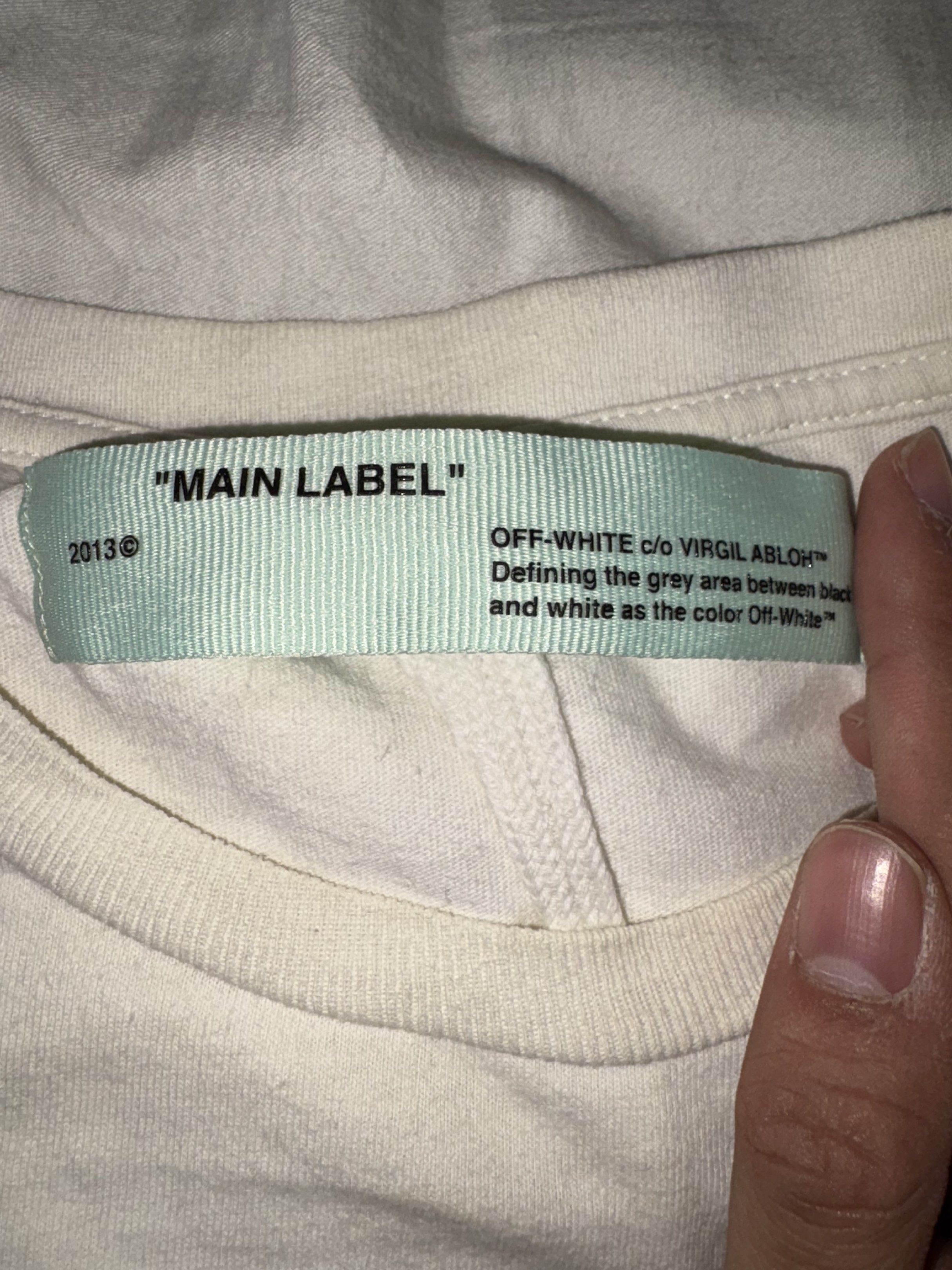 Off-White White T-shirt (Category: Tshirts & Polo Shirts ) located in Taguig. Submitted by homieplugph (Listing ID 1417993999, Image 2). Description: - Off-White White T-shirt - Size: XXS on tags (fits Large) - Features the iconic "OFF" logo - Excellent condition - Authentic Off-White.