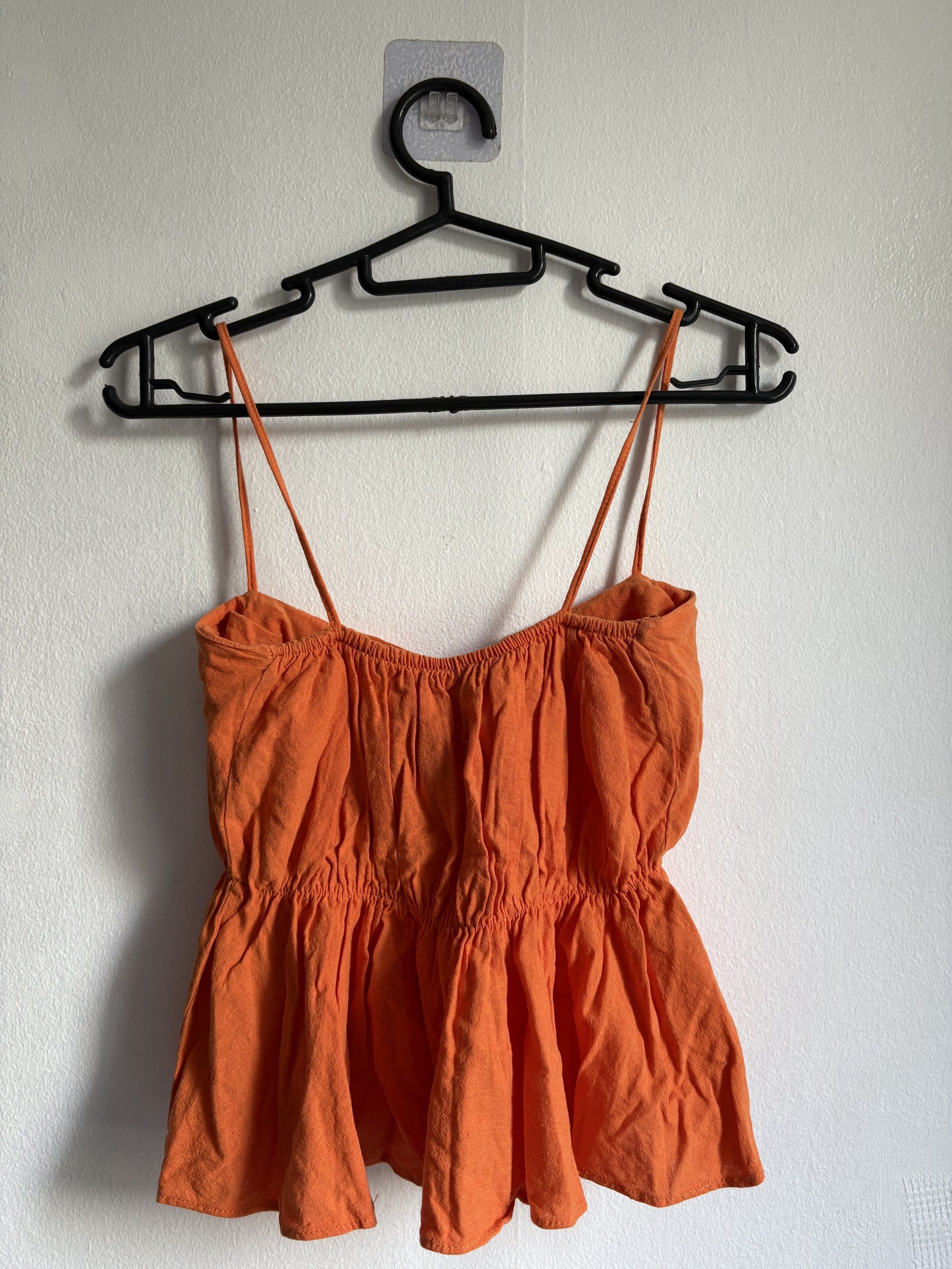 Orange Spaghetti Strap Top (Category: Sleeveless) located in Quezon City. Submitted by secondlifeph001 (Listing ID 1417905356, Image 2). Description: - Orange spaghetti strap top - Square neckline - Flared hem - Lightweight fabric - Suitable for warm weather - Perfect for casual wear.