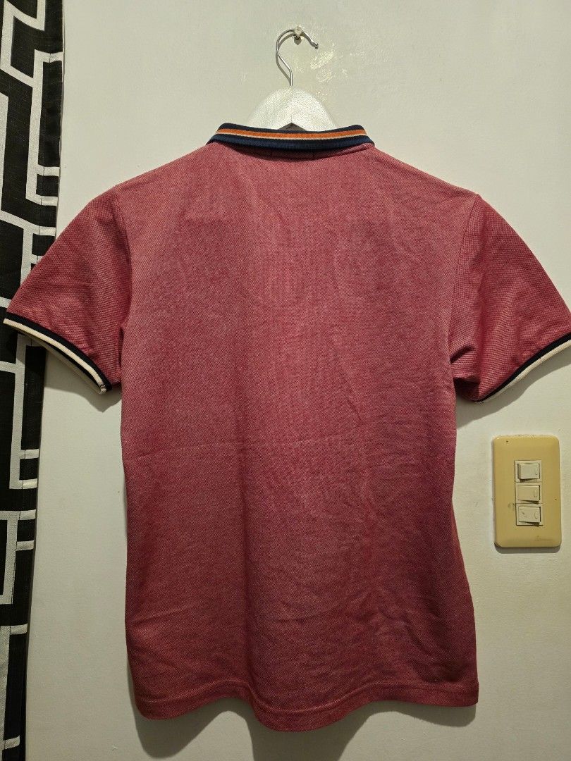 Red Polo Shirt with Striped Collar (Category: Tshirts & Polo Shirts ) located in Taguig. Submitted by bandsaccount (Listing ID 1417929944, Image 2). Description: - Classic red polo shirt - Collared neckline - Navy, orange, and white striped collar detail - White and navy sleeve trim - Button-up placket - Textured fabric - Versatile for casual wear.