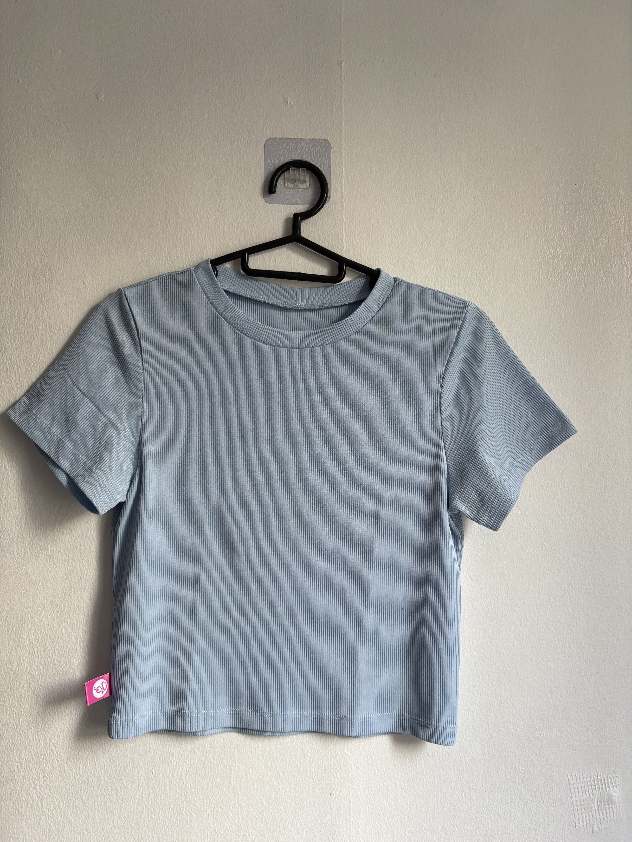 Ribbed Crop Top (Category: Shirts) located in Quezon City. Submitted by secondlifeph001 (Listing ID 1417905945, Image 1). Description: - Light blue ribbed crop top - Round neckline - Short sleeves - Lightweight fabric - Features a logo tag - Perfect for casual wear.