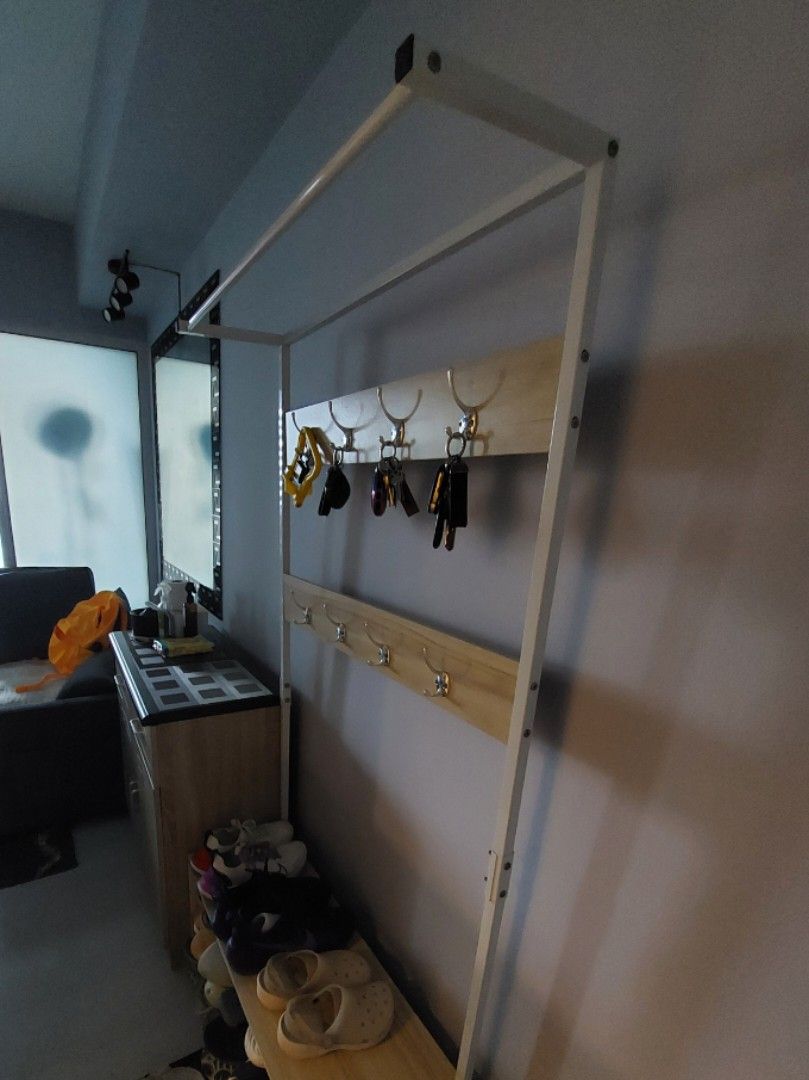 Shoe Rack with Hanger (Category: Shelves, Cabinets & Racks) located in Paranaque City. Submitted by erick_e (Listing ID 1417897862, Image 2). Description: -1pc Shoe rack Multi purpose -2nd hand 3yrs used -Double layer shoe rack - Metal frame with wooden planks -With key holder - Features hooks for hanging items - Provides ample shoe storage - Suitable for various shoe sizes and styles -Reason for selling Need more space on condo -available for pi