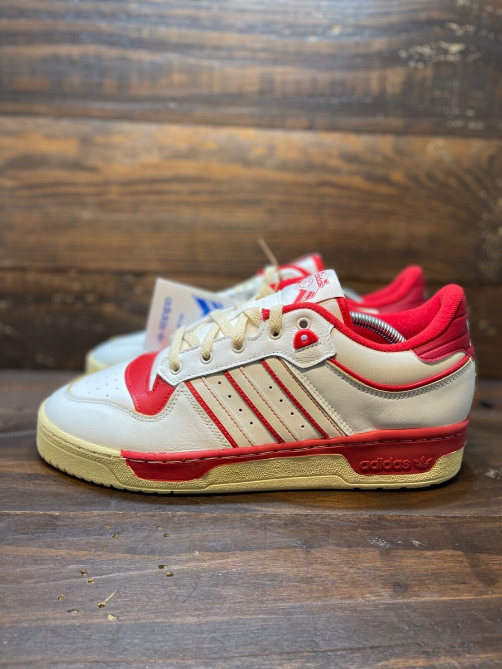 Size11.5 Adidas Rivalry Low (Category: Sneakers) located in Las Pinas. Submitted by volerb (Listing ID 1417983362, Image 1). Description: - Adidas Rivalry Low sneakers - Color: White with red accents - Features the iconic three stripes - Cream-colored sole - Red accents on heel and tongue - Adidas logo visible - Includes original tag.