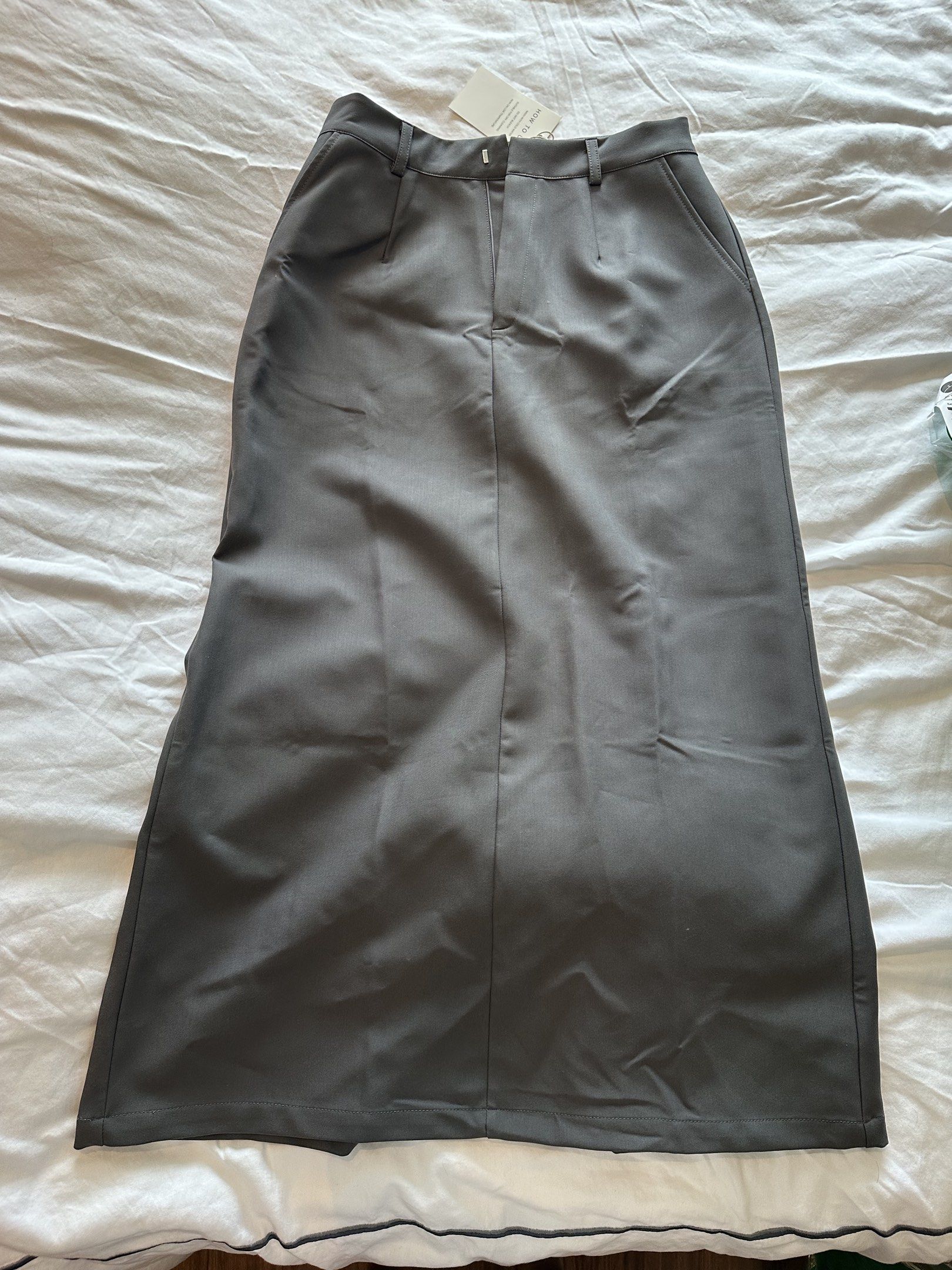 SOMS Gray Maxi Skirt - Size L (Category: Skirts) located in Quezon City. Submitted by krishagee (Listing ID 1417889334, Image 1). Description: - SWOS gray maxi skirt - Size: L - High-waisted - Button closure - Features pockets - Material: Smooth, woven fabric - Silhouette: Long, straight.