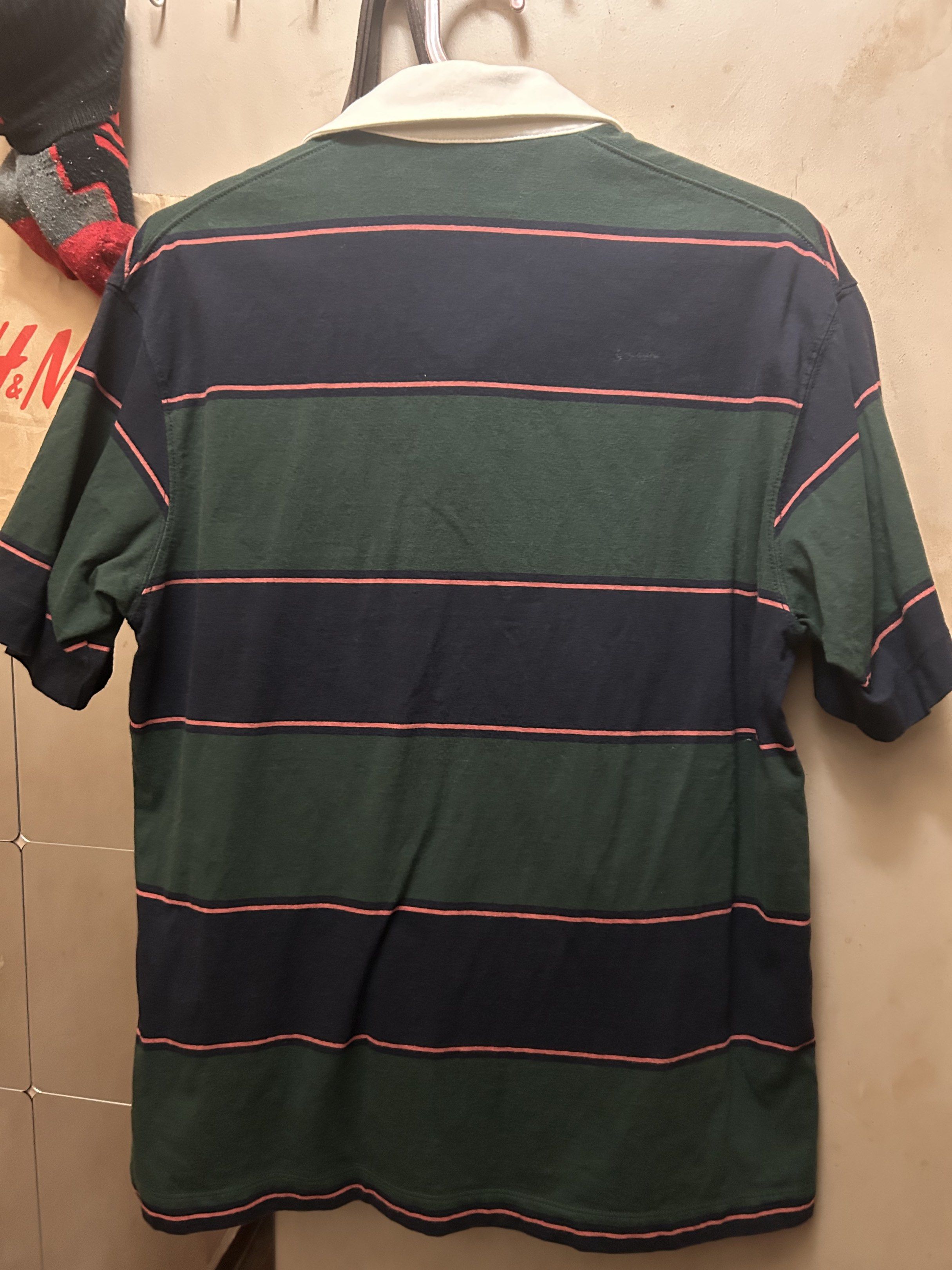 Striped Rugby Shirt (Category: Tshirts & Polo Shirts ) located in Manila. Submitted by keyscaninet (Listing ID 1417874367, Image 2). Description: - Classic rugby shirt - Striped design: green, navy, and pink - White collar - Button-up neckline - Short-sleeved - Casual style - Comfortable fabric.