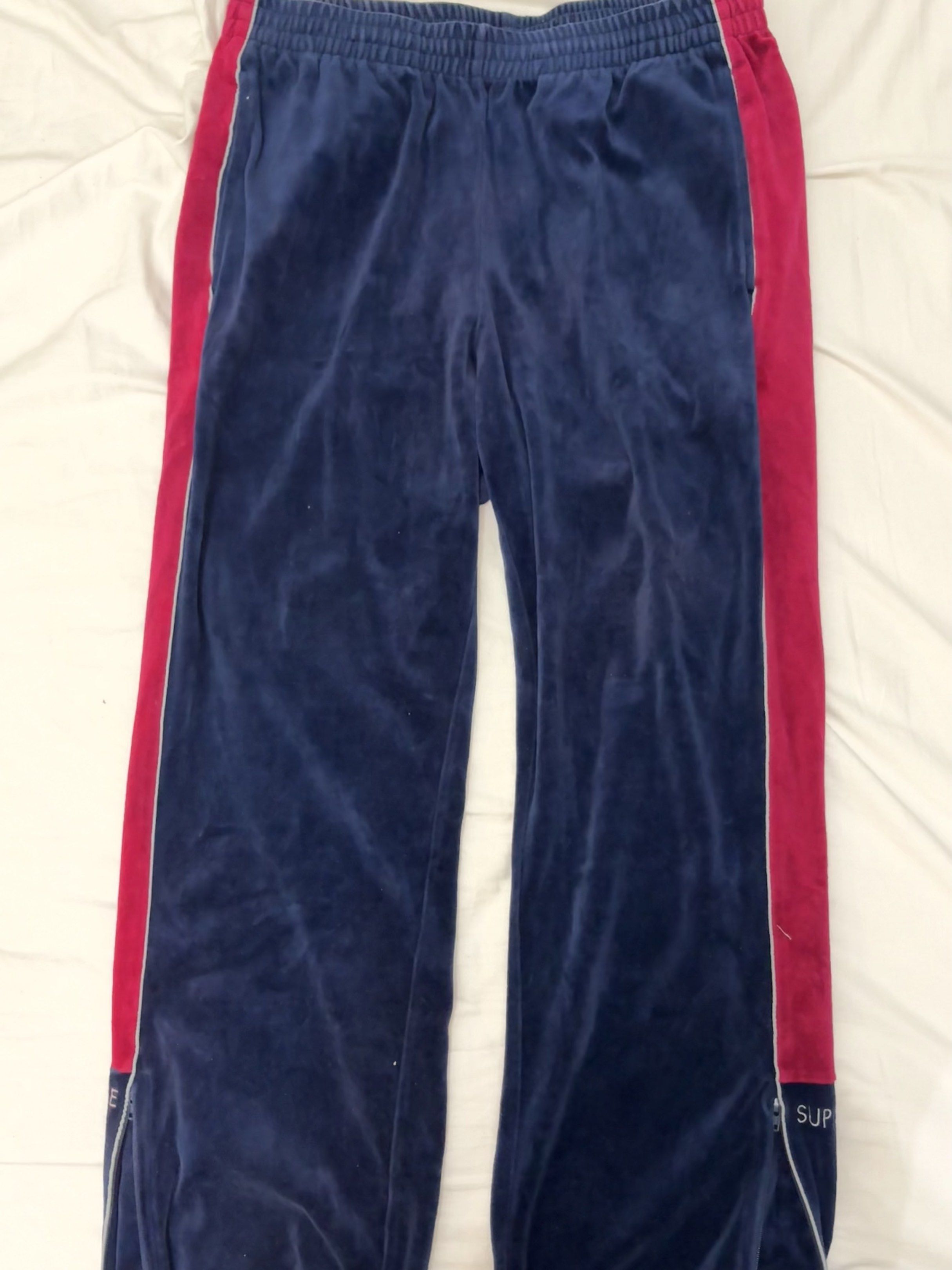 Supreme Velour Track Pants (Category: Joggers) located in Taguig. Submitted by homieplugph (Listing ID 1417996133, Image 1). Description: - Supreme Velour Track Pants - Size: Medium - Color: Navy blue with red side panels - Material: Velour - Features Supreme branding - Condition: Excellent.