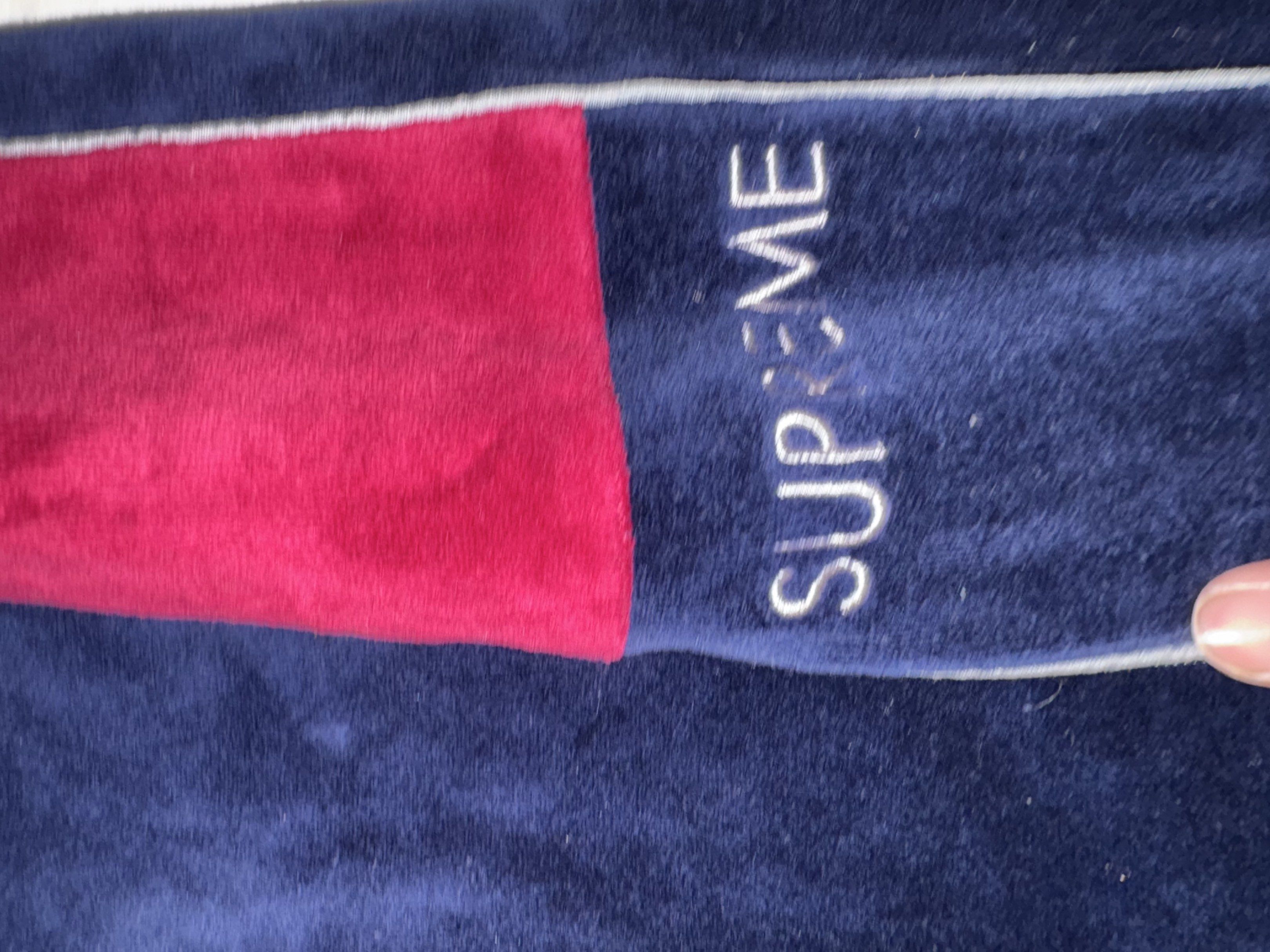Supreme Velour Track Pants (Category: Joggers) located in Taguig. Submitted by homieplugph (Listing ID 1417996133, Image 2). Description: - Supreme Velour Track Pants - Size: Medium - Color: Navy blue with red side panels - Material: Velour - Features Supreme branding - Condition: Excellent.