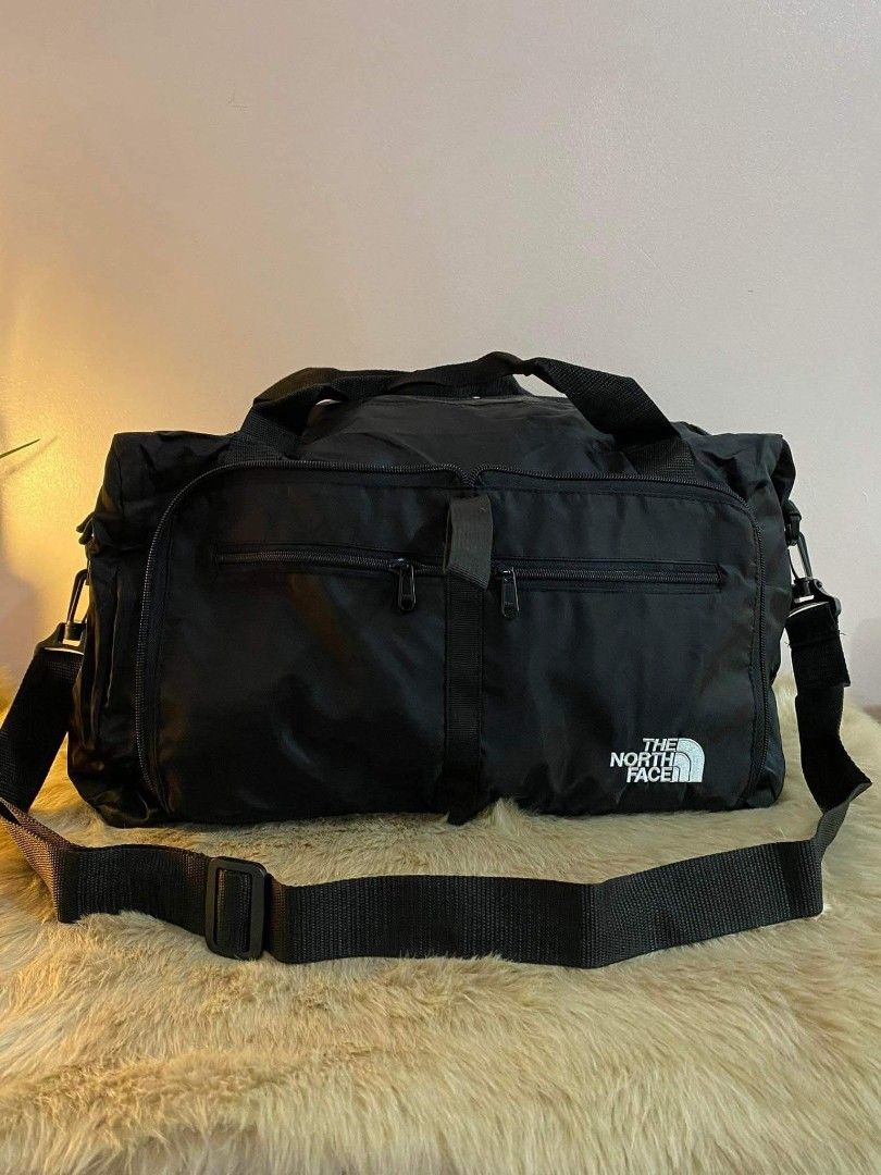 The North Face Packable Duffle Bag (Category: Backpacks) located in Balanga. Submitted by bltzkrg0 (Listing ID 1417933168, Image 2). Description: - The North Face duffle bag - Packable design with included storage pouch - Colors available: Black , Dark Gray & Gray - Features: - Main compartment - Two front pockets - Shoulder strap - North Face logo on the front - Folds for compact storage and travel.