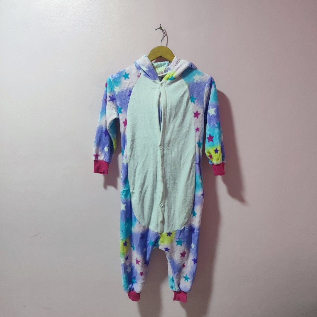 Unicorn Onesie with Star Pattern (Category: Babies & Kids Fashion) located in Bulacan. Submitted by somethingblue02 (Listing ID 1417887356, Image 1). Description: - Needs to repair one button - Adorable unicorn onesie - Features a colorful star pattern - Comes with a unicorn face hood - Convenient zipper closure - Pink cuffs and ankles - Made of soft, plush material - Ideal for lounging or costume parties.