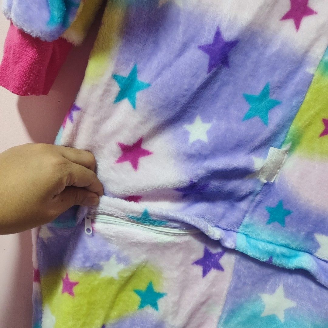 Unicorn Onesie with Star Pattern (Category: Babies & Kids Fashion) located in Bulacan. Submitted by somethingblue02 (Listing ID 1417887356, Image 2). Description: - Needs to repair one button - Adorable unicorn onesie - Features a colorful star pattern - Comes with a unicorn face hood - Convenient zipper closure - Pink cuffs and ankles - Made of soft, plush material - Ideal for lounging or costume parties.