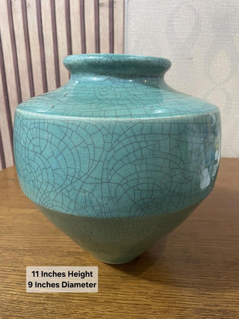 Vintage Celadon Crackle Glaze Vase (Category: Vases & Decorative Bowls) located in Manila. Submitted by ph_collection (Listing ID 1417976672, Image 2). Description: - Vintage celadon vase - Unique crackle glaze - Two-tone design: lighter green base, turquoise upper - Distinctive shape: flared base, narrow neck - Approximately 11 inches tall - Approximately 9 inches diameter - Stamped base.