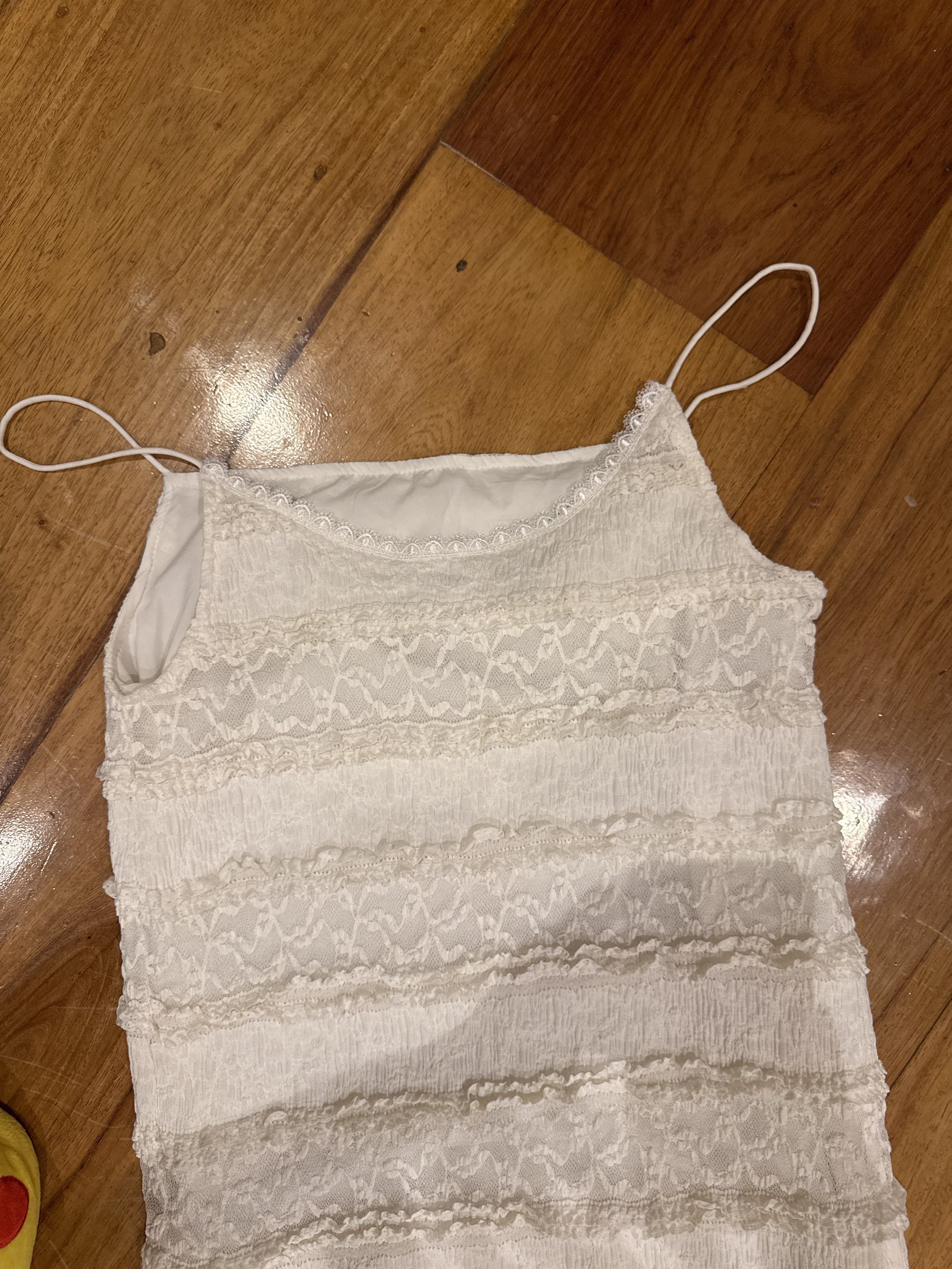 White Lace Dress (Category: Dresses) located in Manila. Submitted by eb.declutters (Listing ID 1417950713, Image 2). Description: - Elegant white dress - Delicate lace detailing - Spaghetti straps - Layered design - Flattering silhouette - Lightweight fabric - Versatile for various occasions Fits small to medium.