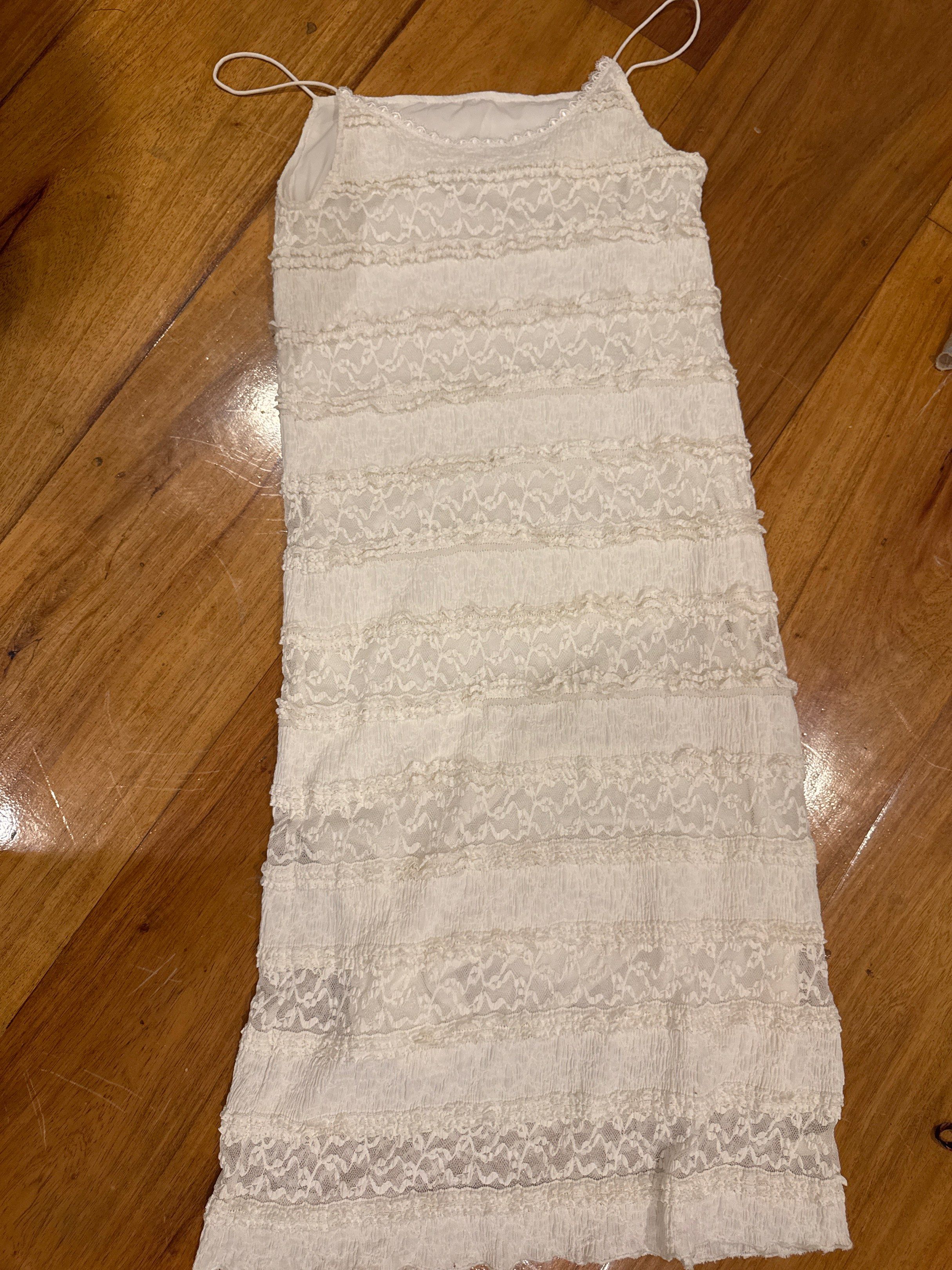 White Lace Dress (Category: Dresses) located in Manila. Submitted by eb.declutters (Listing ID 1417950713, Image 1). Description: - Elegant white dress - Delicate lace detailing - Spaghetti straps - Layered design - Flattering silhouette - Lightweight fabric - Versatile for various occasions Fits small to medium.