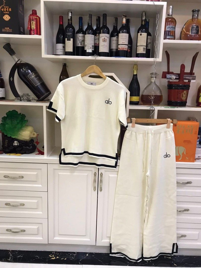 Yoga Sweatshirt and Pants Set (Category: Activewear) located in Manila. Submitted by raredeer-4deb4e (Listing ID 1417837355, Image 2). Description: - Alo Yoga set includes a short-sleeved sweatshirt and matching pants. - Sweatshirt features a crew neck and white trim on sleeves and hem. - Pants have a drawstring waist and white trim at the hem. - Both pieces are branded with the Alo logo. - Available colors: Pink and Beige..