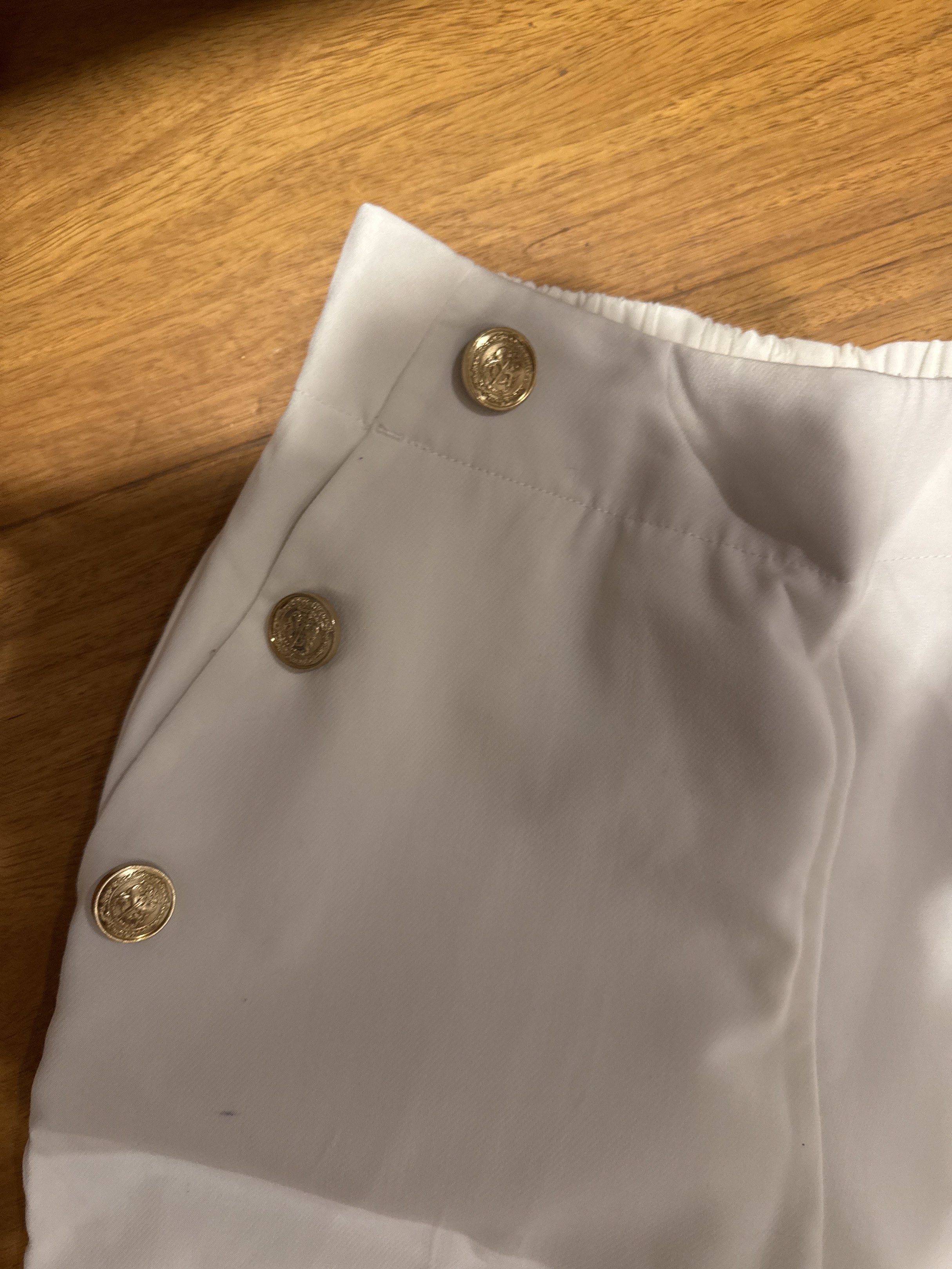 Zara White Pants with Gold Buttons (Category: Other Bottoms) located in Manila. Submitted by eb.declutters (Listing ID 1417953001, Image 3). Description: - Zara white pants - Gold button details - missing one gold button - Straight leg cut - Elastic waistband - Size: XS - Made in Cambodia - Versatile for casual and semi-formal outfits.