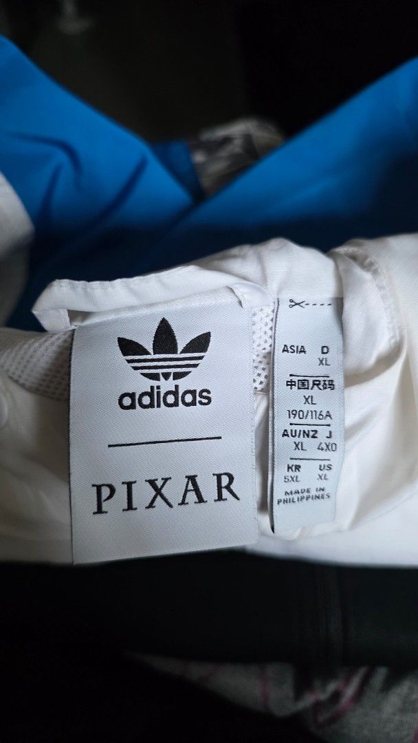 Adidas x Pixar Limited Edition Jacket (Category: Coats, Jackets and Outerwear) located in Mandaluyong City. Submitted by KenP07 (Listing ID 1418070272, Image 2). Description: - Adidas x Pixar Limited Edition Jacket - Size: L/XL - Color: White body with blue sleeves - Features comic-style print inner lining - Hooded with zipper closure - Includes Adidas logo and Pixar label Adidas X Pixar collab Limited Edition X/XL ₽2,500 Pickup : SMDC Light Resi