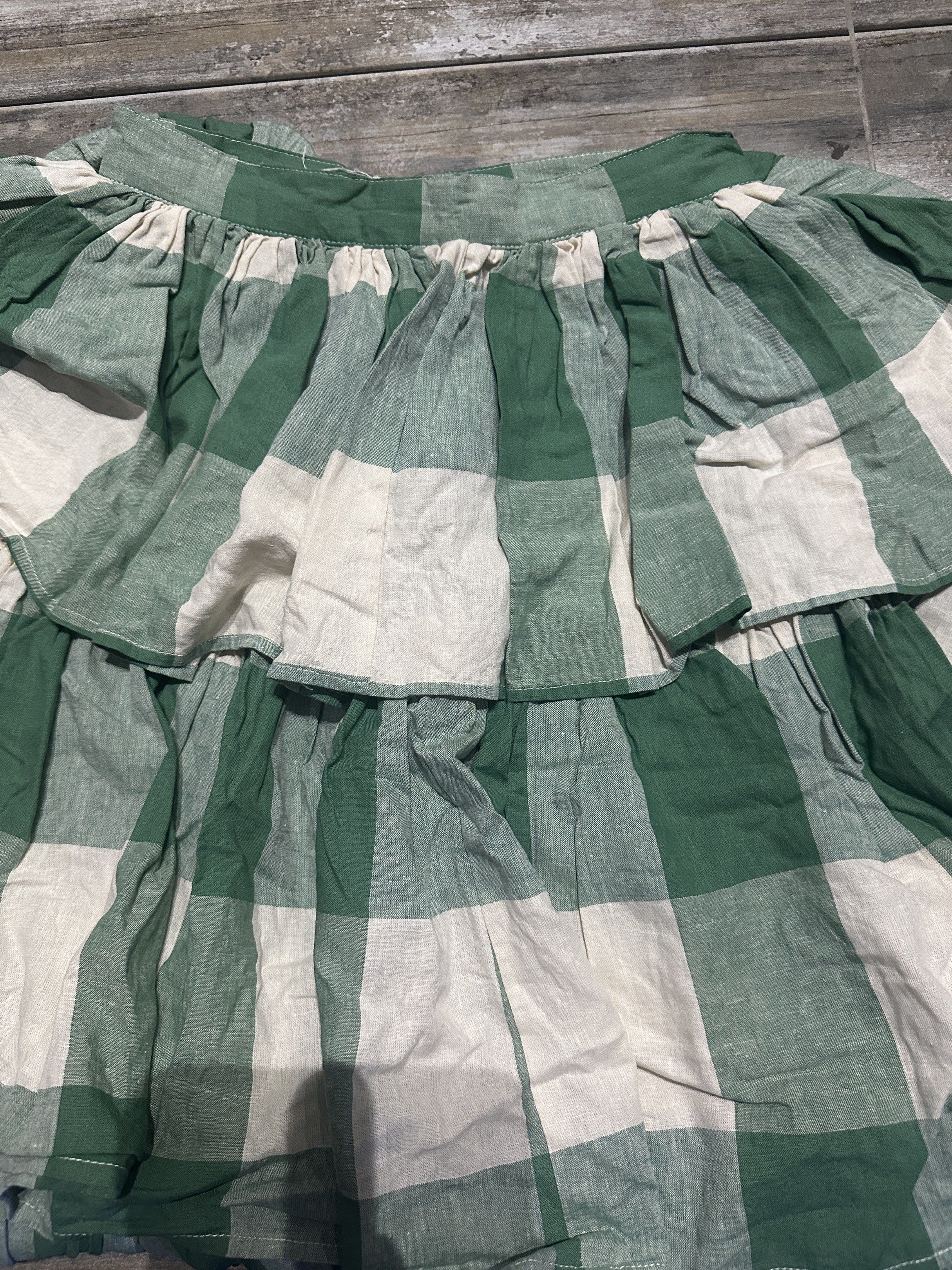 Artisanat Green Checkered Tiered Skirt (Category: Skirts) located in Mabalacat. Submitted by jastin17 (Listing ID 1418107314, Image 1). Description: - Artisanat skirt - Green and white checkered pattern - Size M on tag but fits small - Tiered design - Comfortable fit - Lightweight and breathable fabric - Suitable for warm weather - Perfect for casual or evening wear.