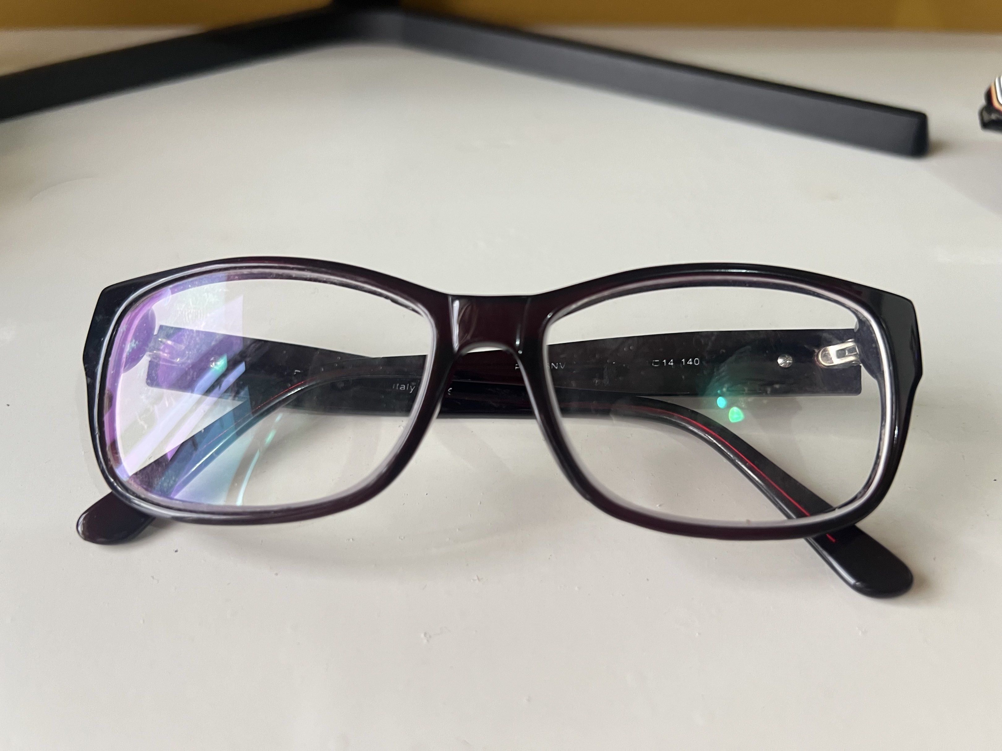 Authentic Prada Eyeglasses (Category: Sunglasses & Eyewear) located in Quezon City. Submitted by bubspreloved (Listing ID 1418081677, Image 1). Description: - Authentic Prada eyeglasses - Dark burgundy rectangular frame - Features the Prada logo on the temples - Equipped with clear lenses - Frame size: 14 140 - Made in Italy.