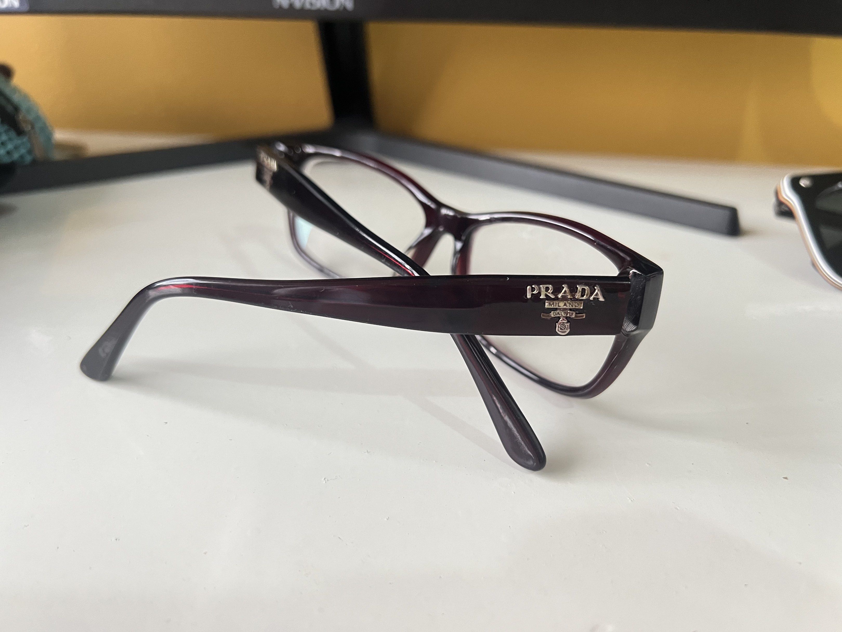 Authentic Prada Eyeglasses (Category: Sunglasses & Eyewear) located in Quezon City. Submitted by bubspreloved (Listing ID 1418081677, Image 3). Description: - Authentic Prada eyeglasses - Dark burgundy rectangular frame - Features the Prada logo on the temples - Equipped with clear lenses - Frame size: 14 140 - Made in Italy.