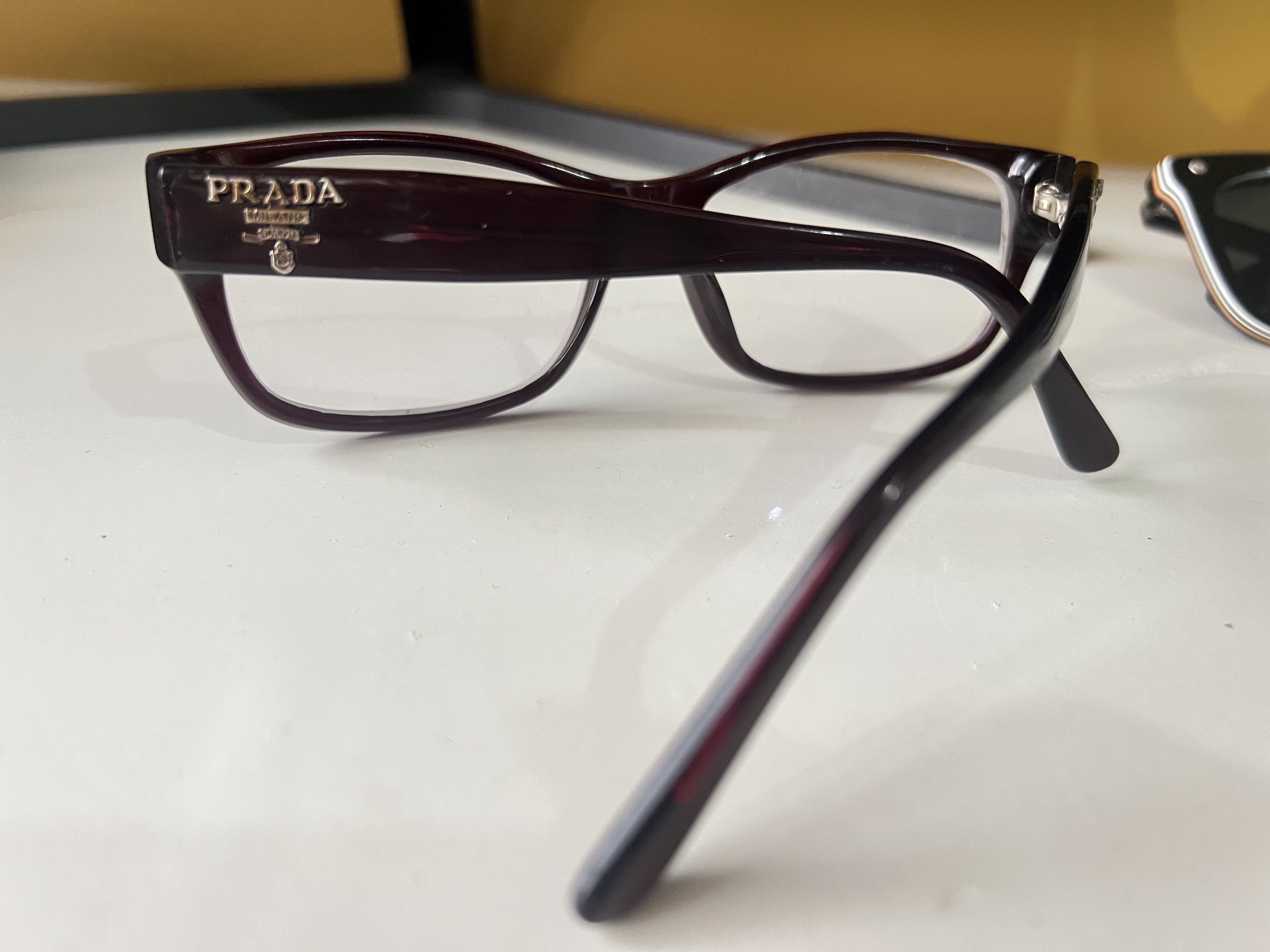Authentic Prada Eyeglasses (Category: Sunglasses & Eyewear) located in Quezon City. Submitted by bubspreloved (Listing ID 1418081677, Image 2). Description: - Authentic Prada eyeglasses - Dark burgundy rectangular frame - Features the Prada logo on the temples - Equipped with clear lenses - Frame size: 14 140 - Made in Italy.
