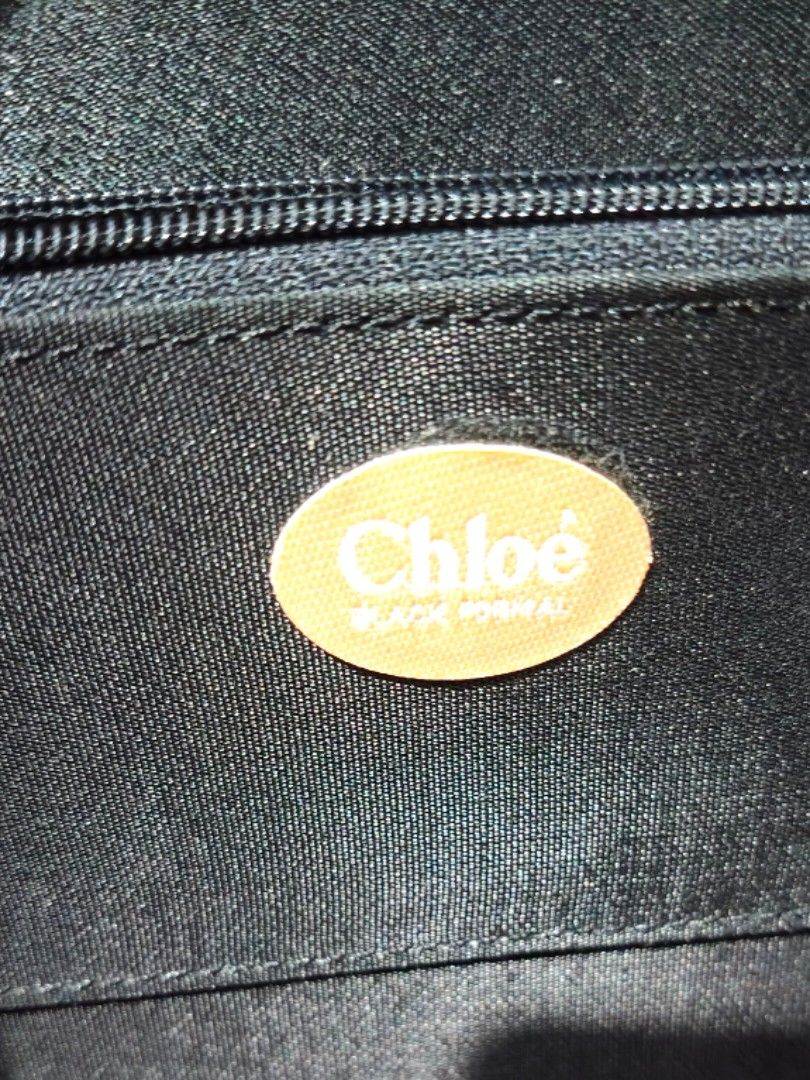 Chloe Black Handbag (Category: Luxury Bags & Wallets) located in Davao. Submitted by caterinem07621 (Listing ID 1418169689, Image 3). Description: - Chloe black handbag - Structured design - Flap closure - Top handle - Interior pockets (small and zipper) - Chloe logo inside - Sleek, minimalist aesthetic - Suitable for various occasions ‼️Brandnew Condition Chloé black formal clutch bag. handle is detachable. No issue! this is actually unused. Sel