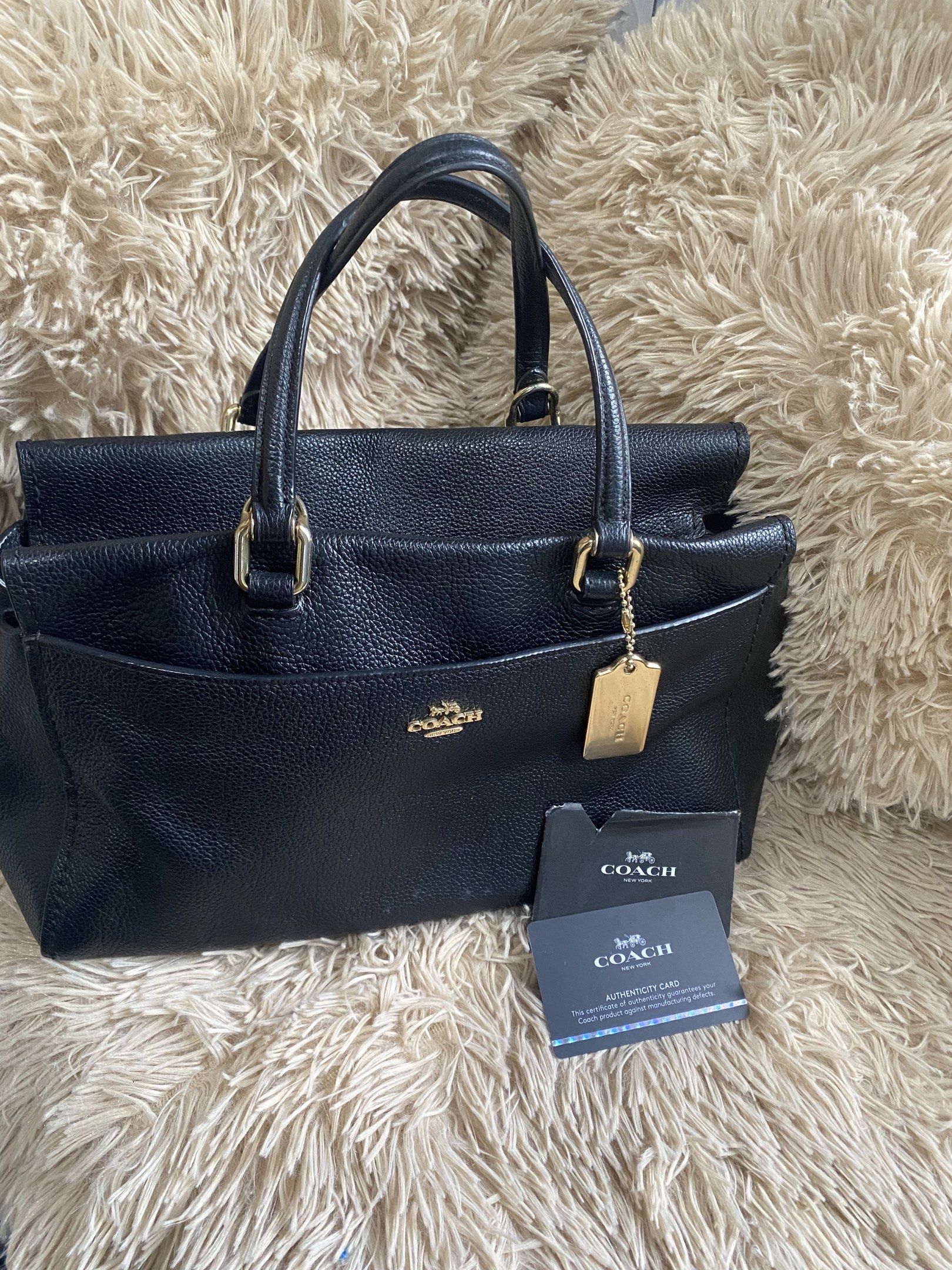 Coach Black Leather Handbag (Category: Luxury Bags & Wallets) located in Iligan City. Submitted by declutter_ann (Listing ID 1418035752, Image 1). Description: - Authentic Coach handbag - Black leather - Classic design - Top handles - Front pocket - Gold-tone hardware - Protective feet - Includes authenticity card and Coach tag - price is still negotiable .