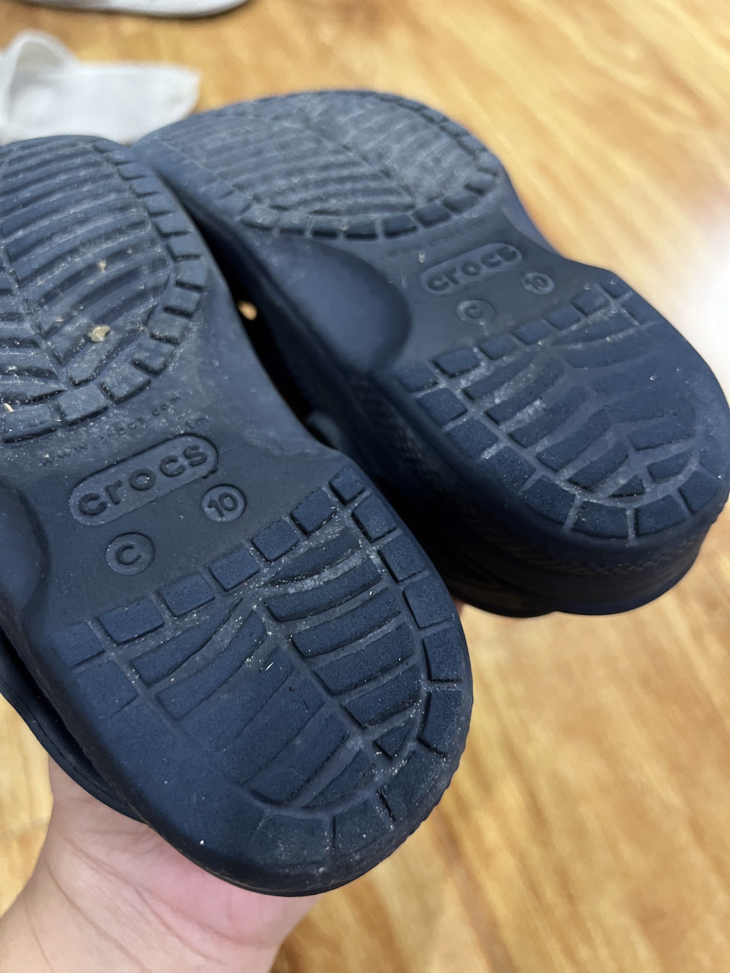 Crocs Classic Clogs - Navy Blue - C10 (Category: Babies & Kids Fashion) located in Rizal. Submitted by ichaaay21 (Listing ID 1418167342, Image 3). Description: - Navy blue Crocs Classic clogs - Size: C10 - Features the Crocs logo - Classic Crocs design with ventilation holes - Shows some wear on the soles - Perfect for casual wear.
