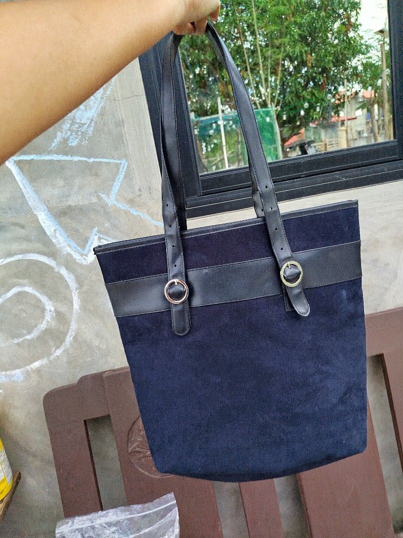 Givenchy Navy Blue Tote Bag (Category: Luxury Bags & Wallets) located in Bayambang. Submitted by himala_samutsari (Listing ID 1418054882, Image 2). Description: - Givenchy navy blue tote bag - Suede-like exterior - Black leather accents and handles - Rectangular shape - Spacious interior - Logo detail on front - Adjustable handles with buckles - Black fabric lining.