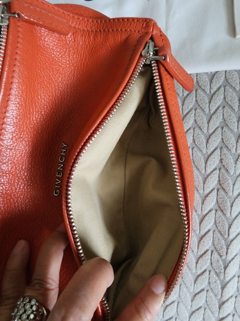 Givenchy Pandora Orange Leather Bag (Category: Luxury Bags & Wallets) located in Quezon City. Submitted by deng43763 (Listing ID 1418043335, Image 2). Description: - Authentic Givenchy Pandora bag - Vibrant orange color - Includes dust bag and card - Top handle and crossbody strap - Silver-tone hardware - Zip closure - Givenchy logo visible.