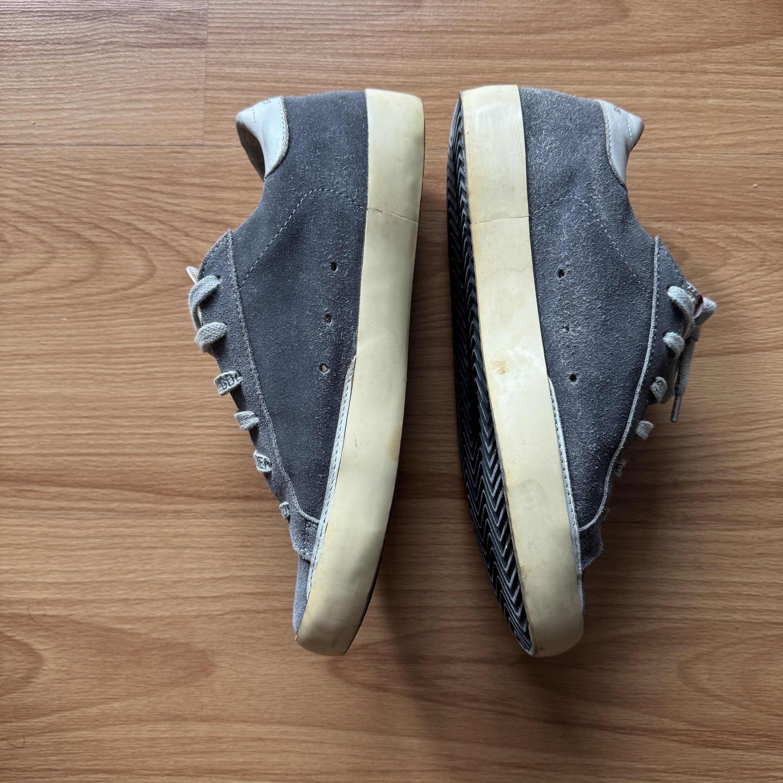 Golden Goose Superstar Sneakers (Category: Sneakers) located in Quezon City. Submitted by thingsforless (Listing ID 1418066440, Image 2). Description: - Golden Goose Superstar sneakers - Grey suede upper - White star detail - Cream-colored sole - White leather accents - Branded laces: "Golden Goose Sneakers" - Leather insole with Golden Goose Deluxe Brand logo - Size 37 24cm Fits US7.