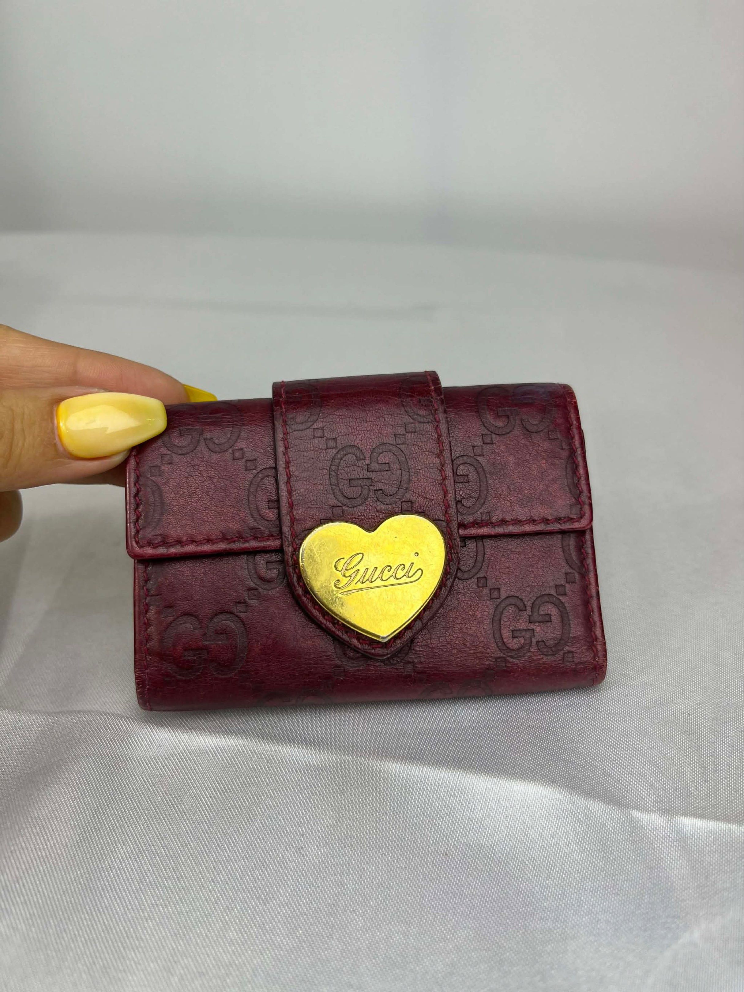 Gucci Heart Key Case (Category: Luxury Bags & Wallets) located in Manila. Submitted by aki7723 (Listing ID 1418124284, Image 2). Description: - Authentic Gucci key case - Deep red color - Gold heart-shaped accent with Gucci logo - Interior key holder and small compartment - Made in Italy - Gucci logo embossed on leather.