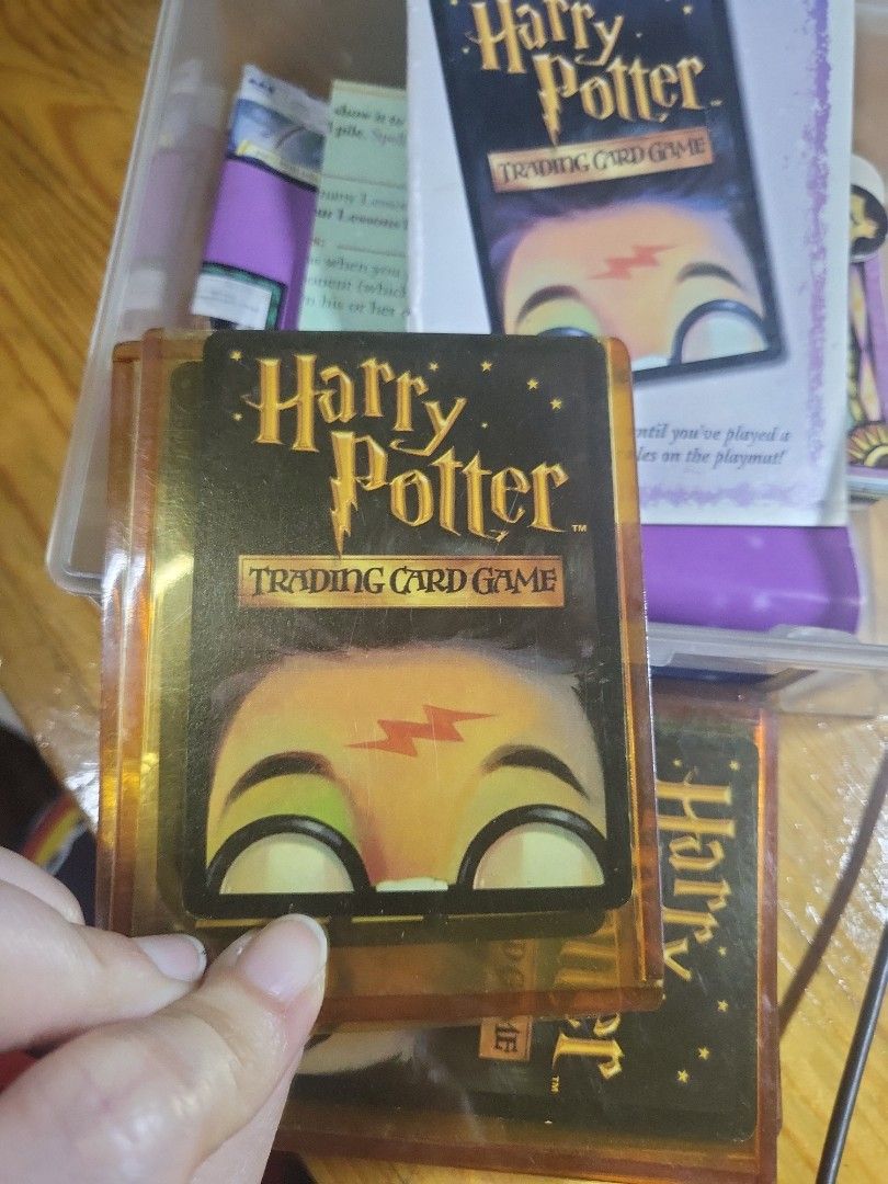 Harry Potter Trading Card Game (Category: Board Games & Puzzles) located in Caloocan City. Submitted by lynette1977 (Listing ID 1418011954, Image 2). Description: - Harry Potter Trading Card Game collection. - Includes various cards. - Features cards like "Hospital Wing" and "Poster Cauldron". - Comes with rule book and other game materials. - Cards are stored in a clear plastic container..