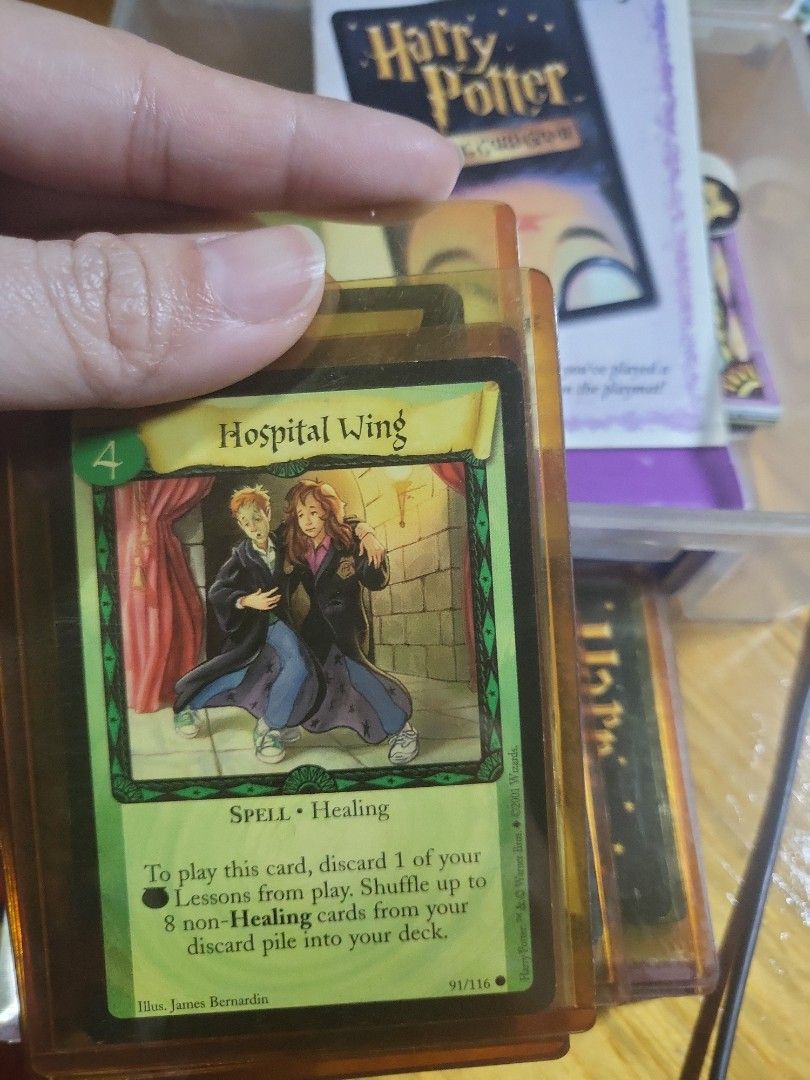 Harry Potter Trading Card Game (Category: Board Games & Puzzles) located in Caloocan City. Submitted by lynette1977 (Listing ID 1418011954, Image 3). Description: - Harry Potter Trading Card Game collection. - Includes various cards. - Features cards like "Hospital Wing" and "Poster Cauldron". - Comes with rule book and other game materials. - Cards are stored in a clear plastic container..