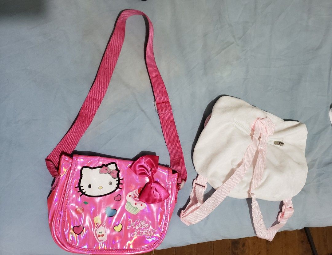 Hello Kitty Shoulder Bag and Backpack Set (Category: Babies & Kids Fashion) located in Manila. Submitted by feg39 (Listing ID 1418023786, Image 2). Description: - Kitty Shoulder Bag: Shiny pink finish, Kitty graphics, bow, and Sanrio tag. - Kitty Backpack: Soft, plush white exterior. - Both bags feature pink straps. - Perfect for Kitty fans!.