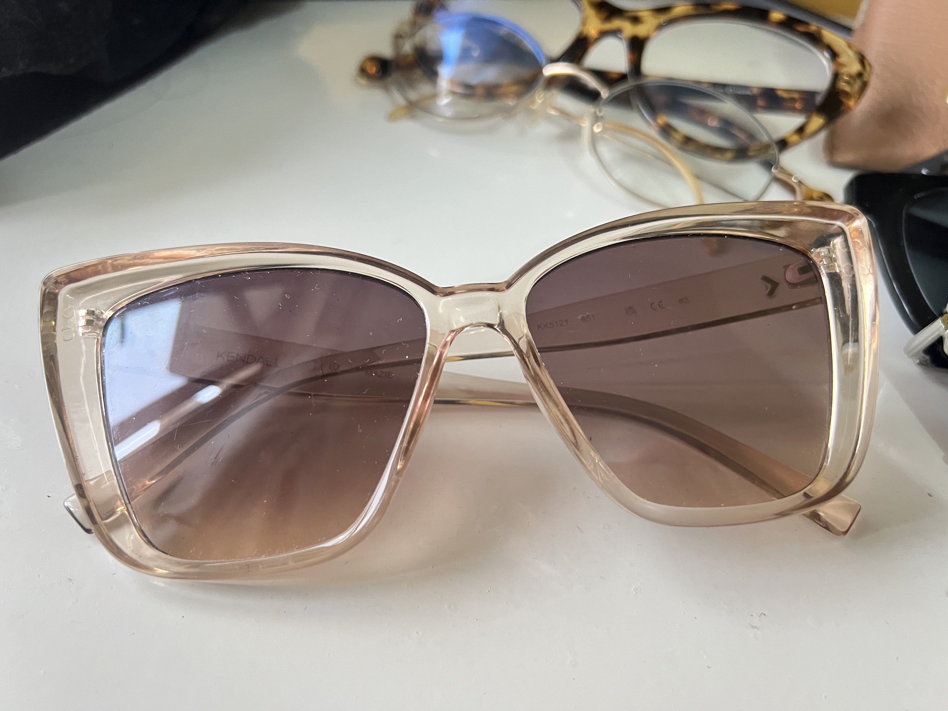 Kendall + Kylie Mazie Sunglasses (Category: Sunglasses & Eyewear) located in Quezon City. Submitted by bubspreloved (Listing ID 1418076894, Image 1). Description: - Kendall + Kylie Mazie sunglasses - Light brown frame - Gradient lenses - Modern square shape - Brand and model visible on arm - Great for sunny days.