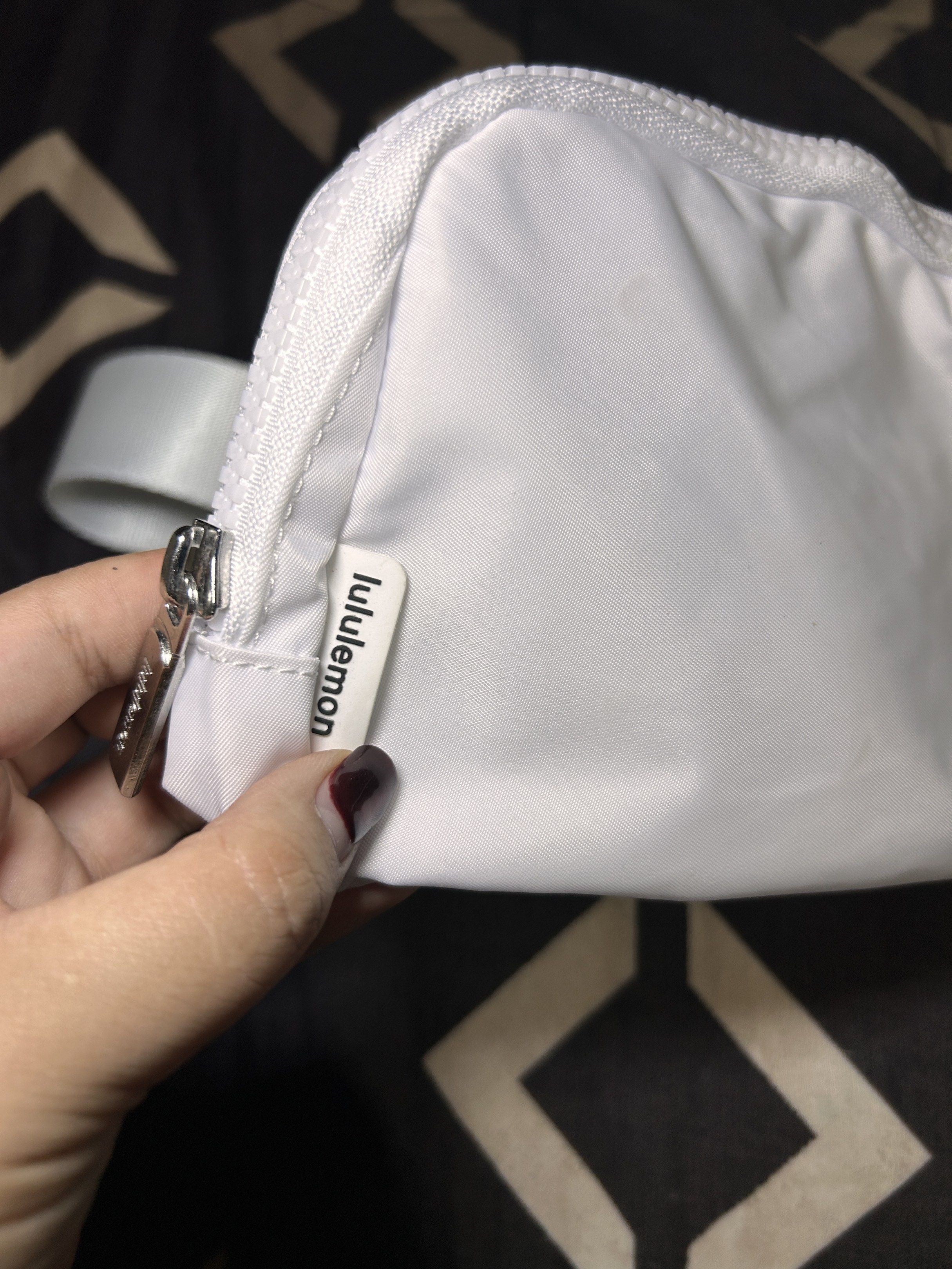 Lululemon Everywhere Belt Bag - White (Category: Cross-body Bags) located in Urdaneta. Submitted by _saphiera (Listing ID 1418197139, Image 2). Description: - Lululemon Everywhere Belt Bag - Color: White - Main compartment with mesh pocket - Smaller internal pocket - Adjustable white strap - Secure zipper closure - Lululemon logo on front and inside - Branded zipper pull Masyadong madumihin for me, may slight stain pero washable naman kayo na bah