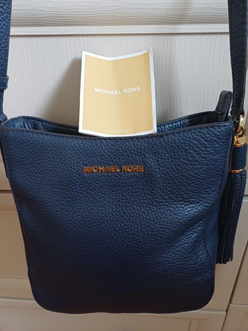 Michael Kors Navy Blue Crossbody Bag (Category: Luxury Bags & Wallets) located in Angeles City. Submitted by dianern (Listing ID 1418054701, Image 3). Description: - Michael Kors crossbody bag - Color: Navy blue - Gold-tone hardware and zipper - Tassel detail - Interior: Zip pocket and slip pocket - Includes tag - Material: Textured leather - no flaws -excellent condition.