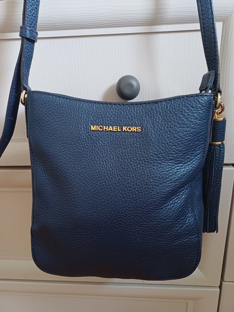 Michael Kors Navy Blue Crossbody Bag (Category: Luxury Bags & Wallets) located in Angeles City. Submitted by dianern (Listing ID 1418054701, Image 2). Description: - Michael Kors crossbody bag - Color: Navy blue - Gold-tone hardware and zipper - Tassel detail - Interior: Zip pocket and slip pocket - Includes tag - Material: Textured leather - no flaws -excellent condition.