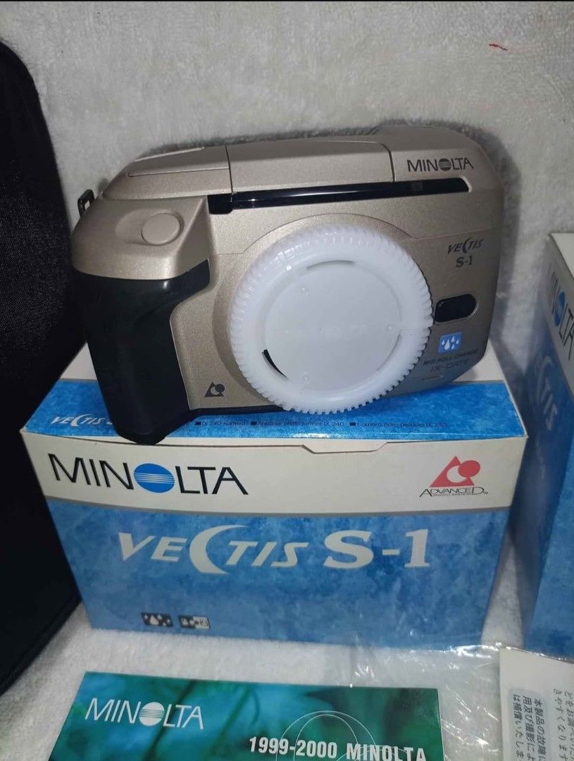 Minolta Vectis S-1 Film Camera Kit (Category: Cameras) located in Quezon City. Submitted by irvinyow (Listing ID 1418152820, Image 2). Description: The Minolta Vectis S1 is a compact and innovative APS (Advanced Photo System) film SLR camera, designed for photographers who want the flexibility of interchangeable lenses in a lightweight package. Released in the late 1990s, it combines Minolta's renowned optics with modern convenience. Includes: - 